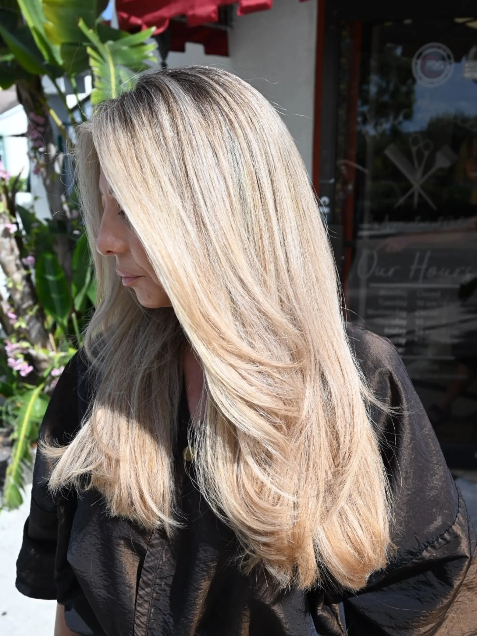 Long, smoothly styled hair featuring bright blonde highlights mixed with a dark natural base, finished with soft layered ends. 1