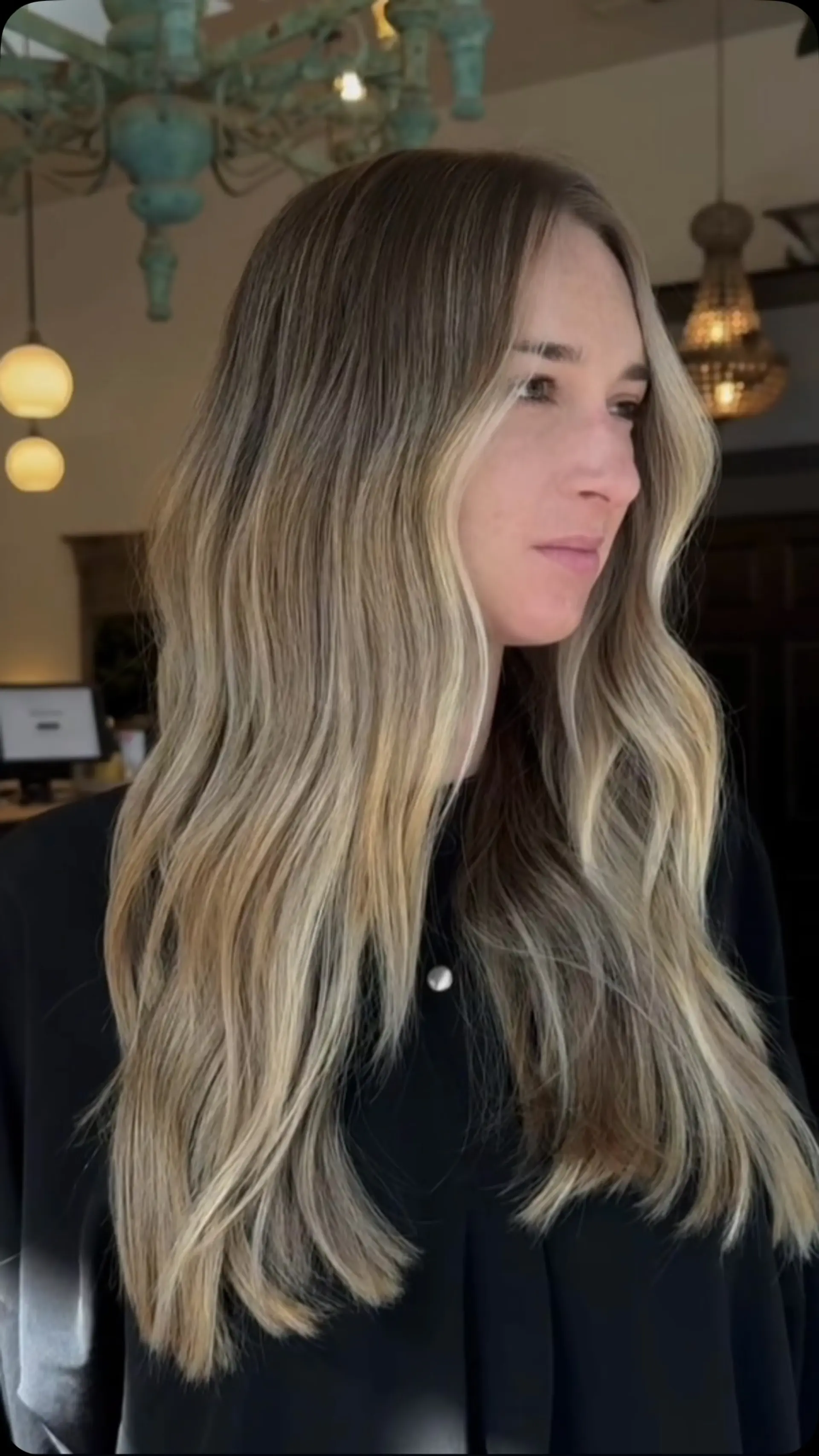 Long dimensional blonde hair styled in loose waves with bright face-framing highlights. 1