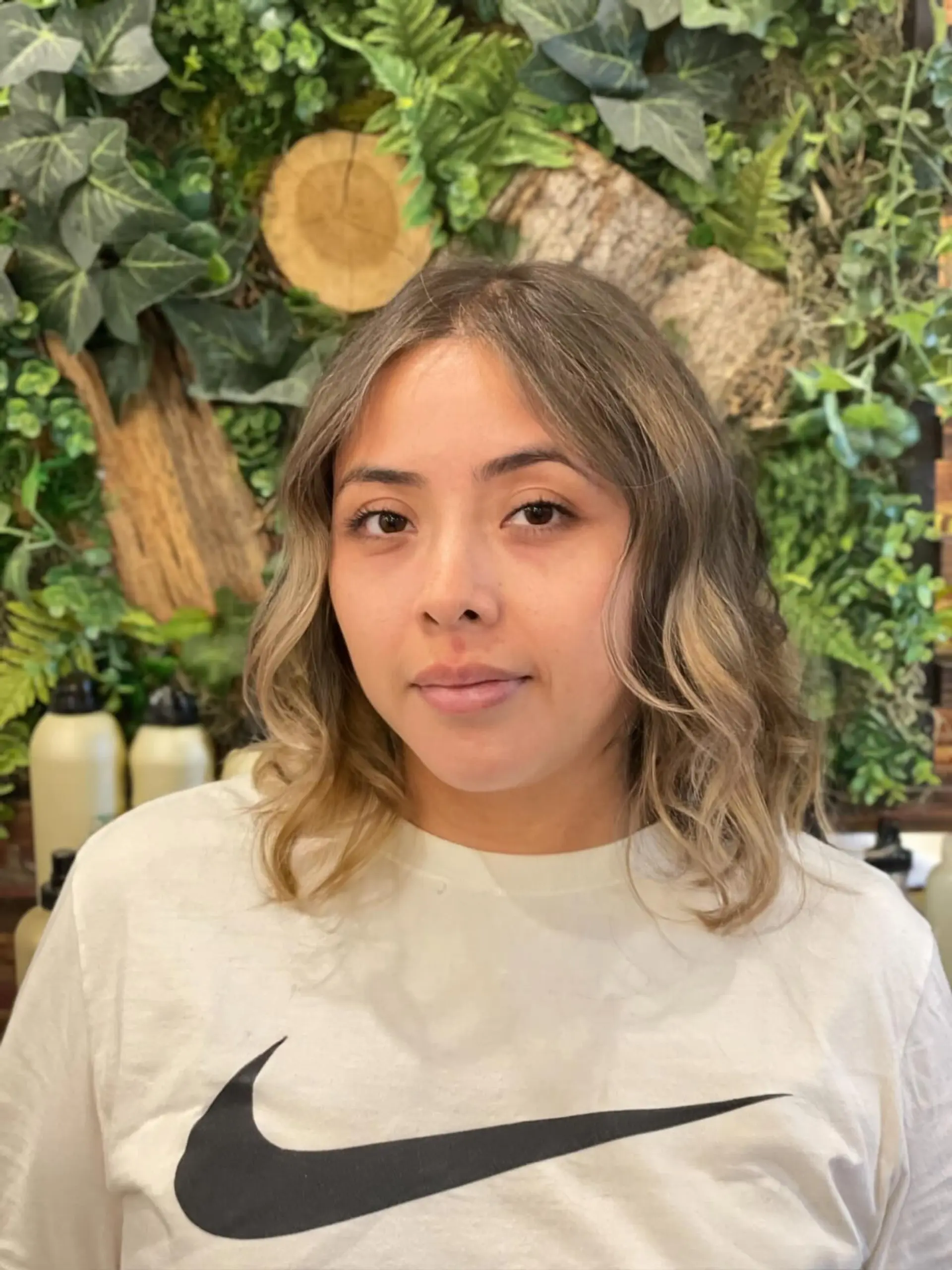 A textured shoulder-length lob featuring soft, undone waves with a dimensional ash blonde balayage. 1