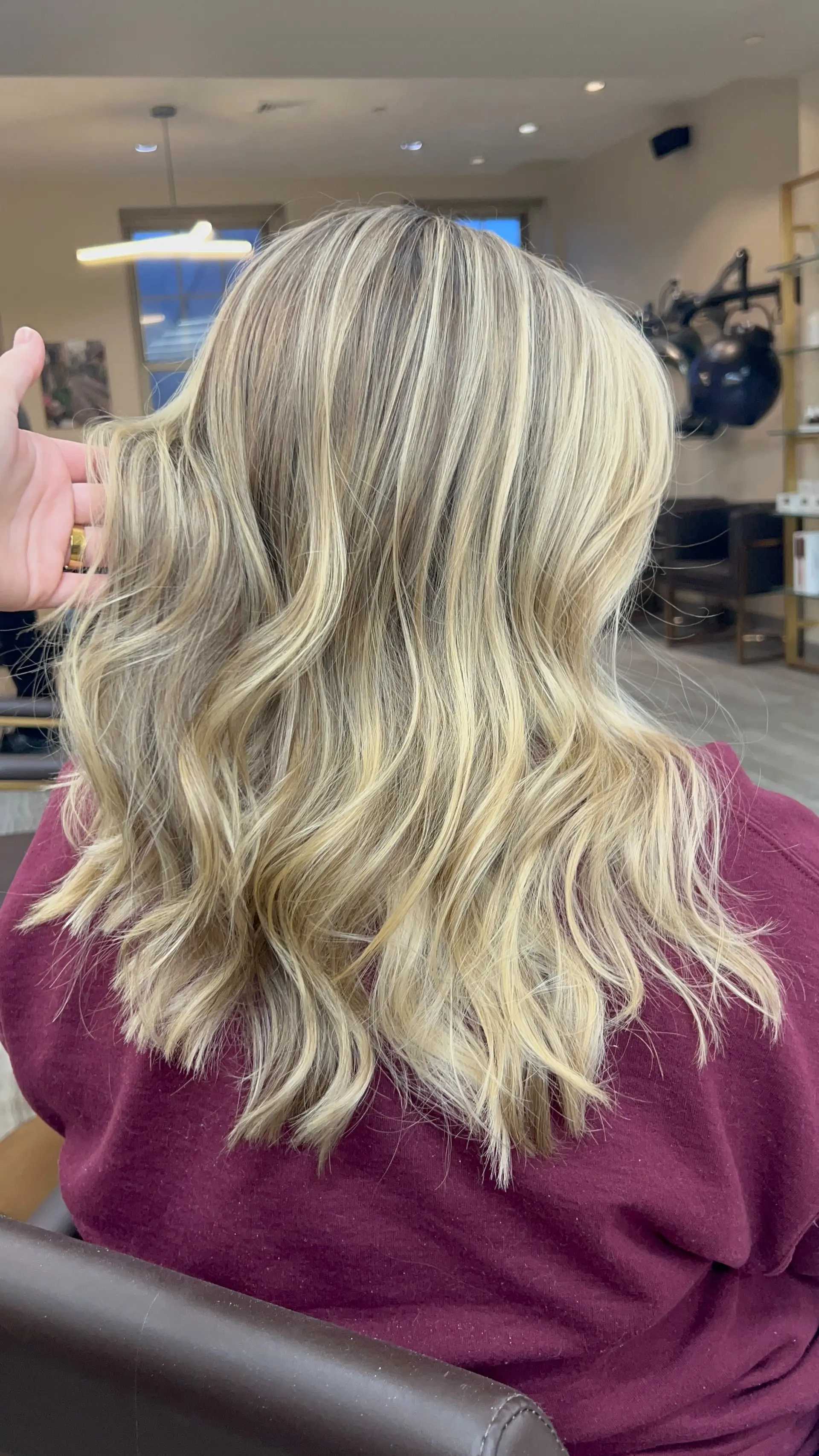 Medium-length dimensional blonde hair styled into soft, effortless waves. 1