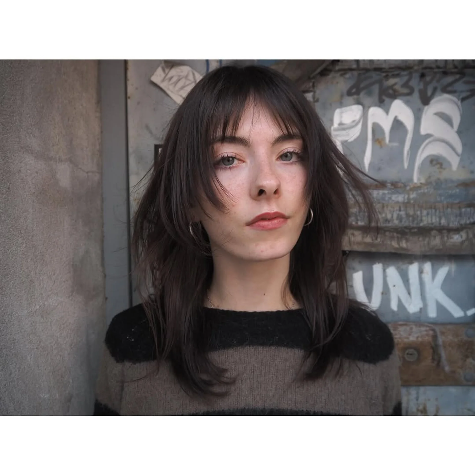 A person with wavy, medium-length teal hair cut into a shag with fringe bangs. - Preview 2