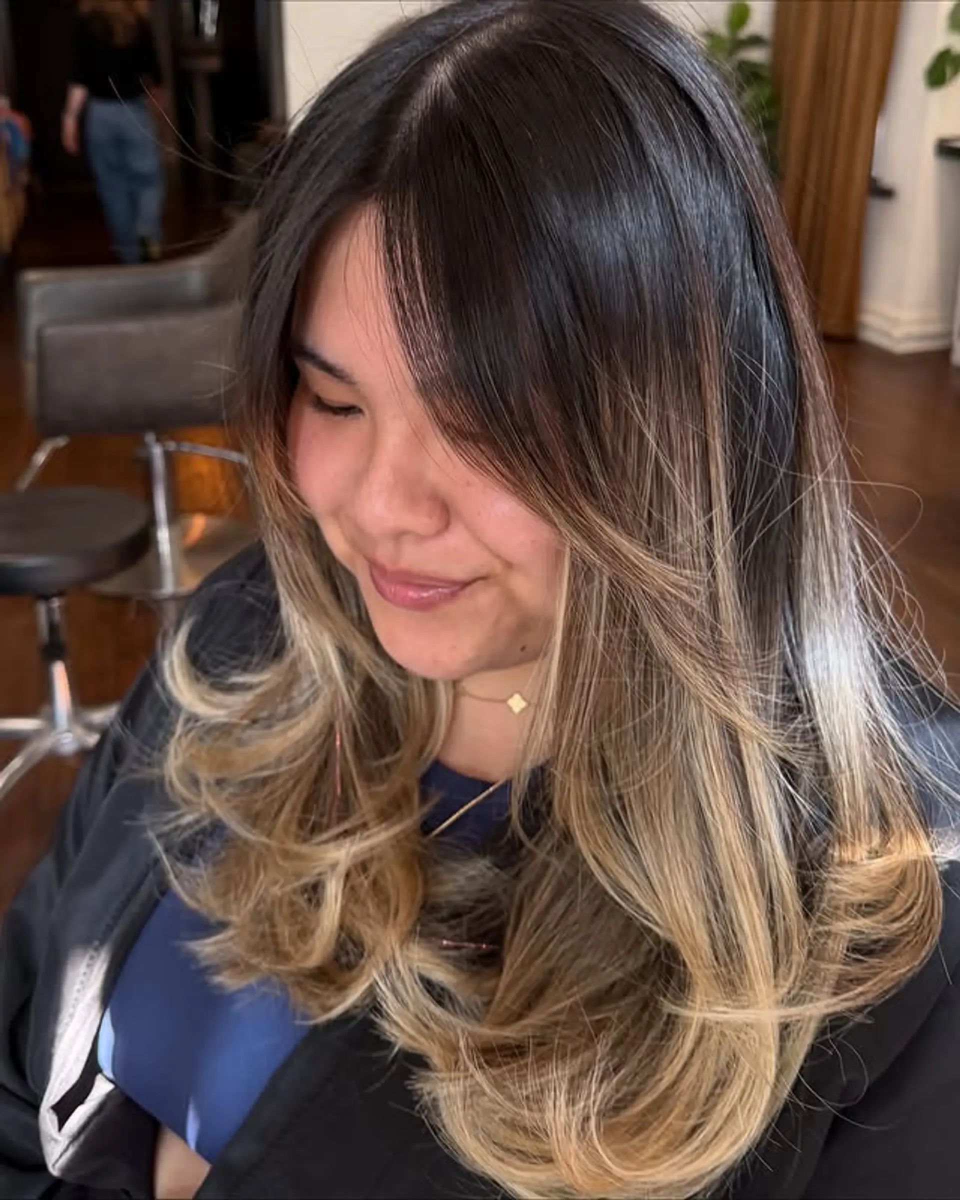 This hairstyle features a rooted blonde balayage with face-framing layers for added dimension. 1