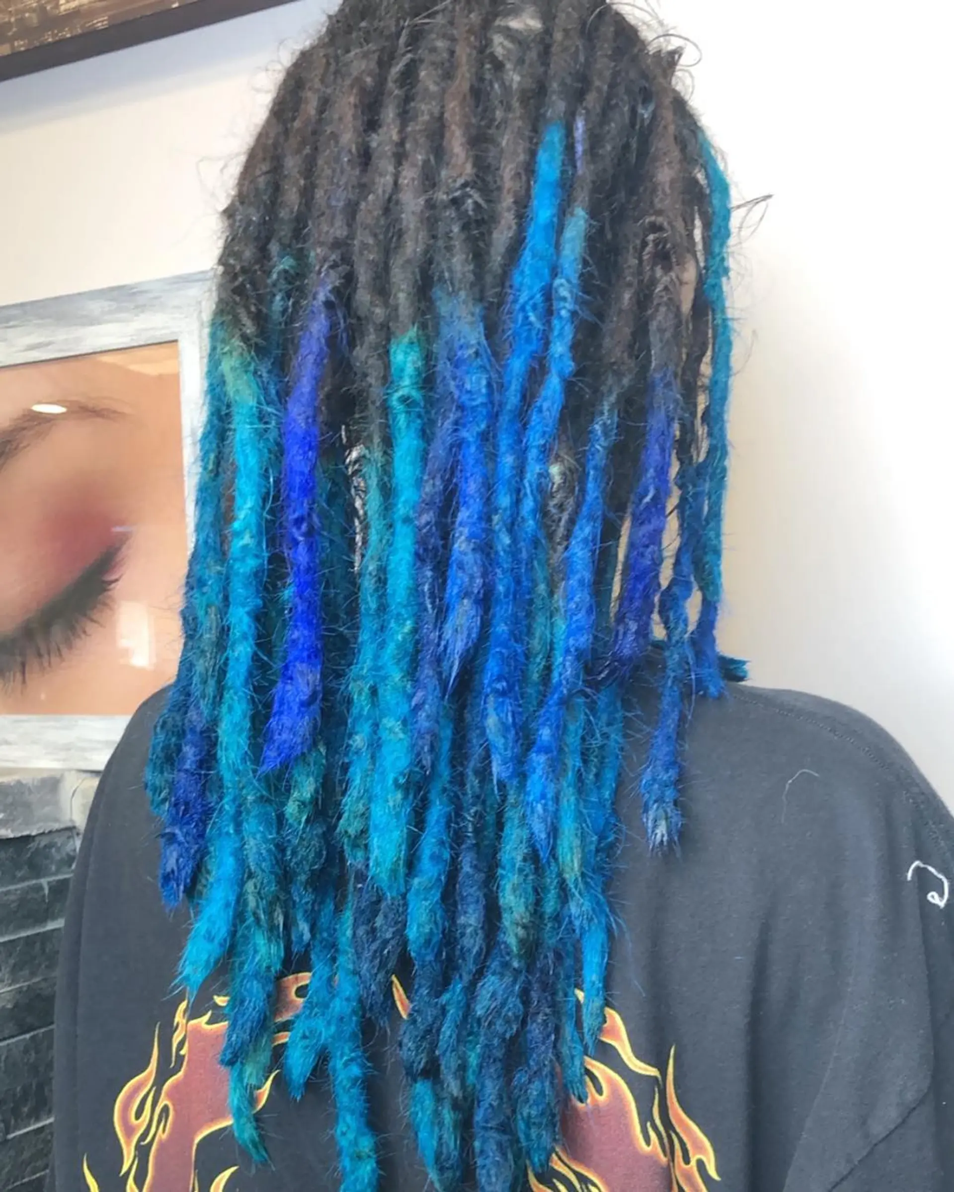 Long, coiled dreadlocks with vibrant blue and bright blue tipped ends, creating an edgy and unique two-tone look. 3
