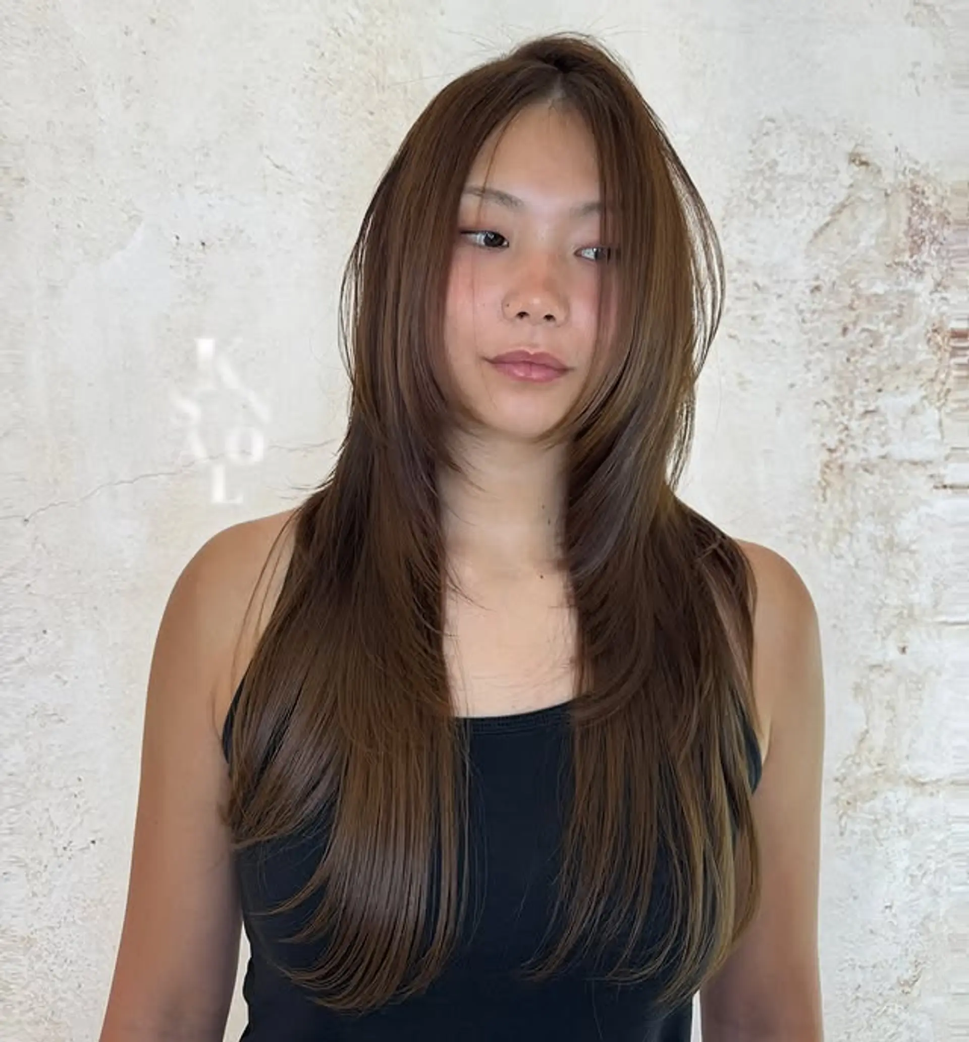 A long layered haircut with face-framing layers. 1