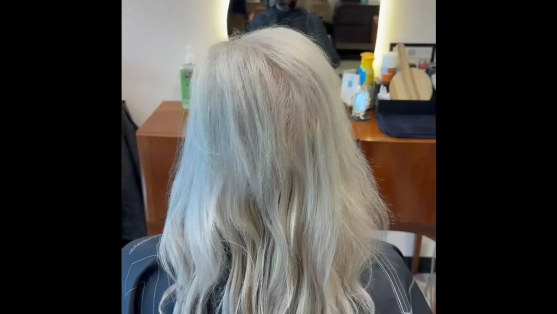 Medium-length icy platinum blonde hair styled with soft, natural texture and gentle waves. 1