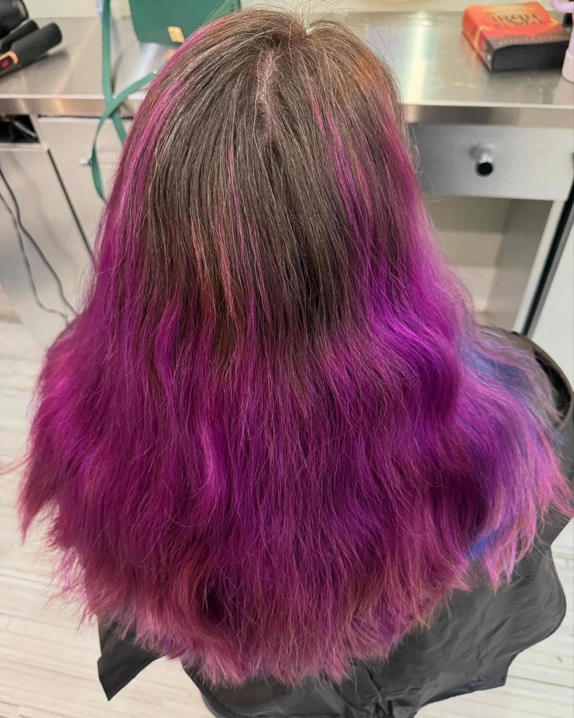 Long wavy brunette hair blending into saturated vivid magenta and purple tones with blue accents. 1
