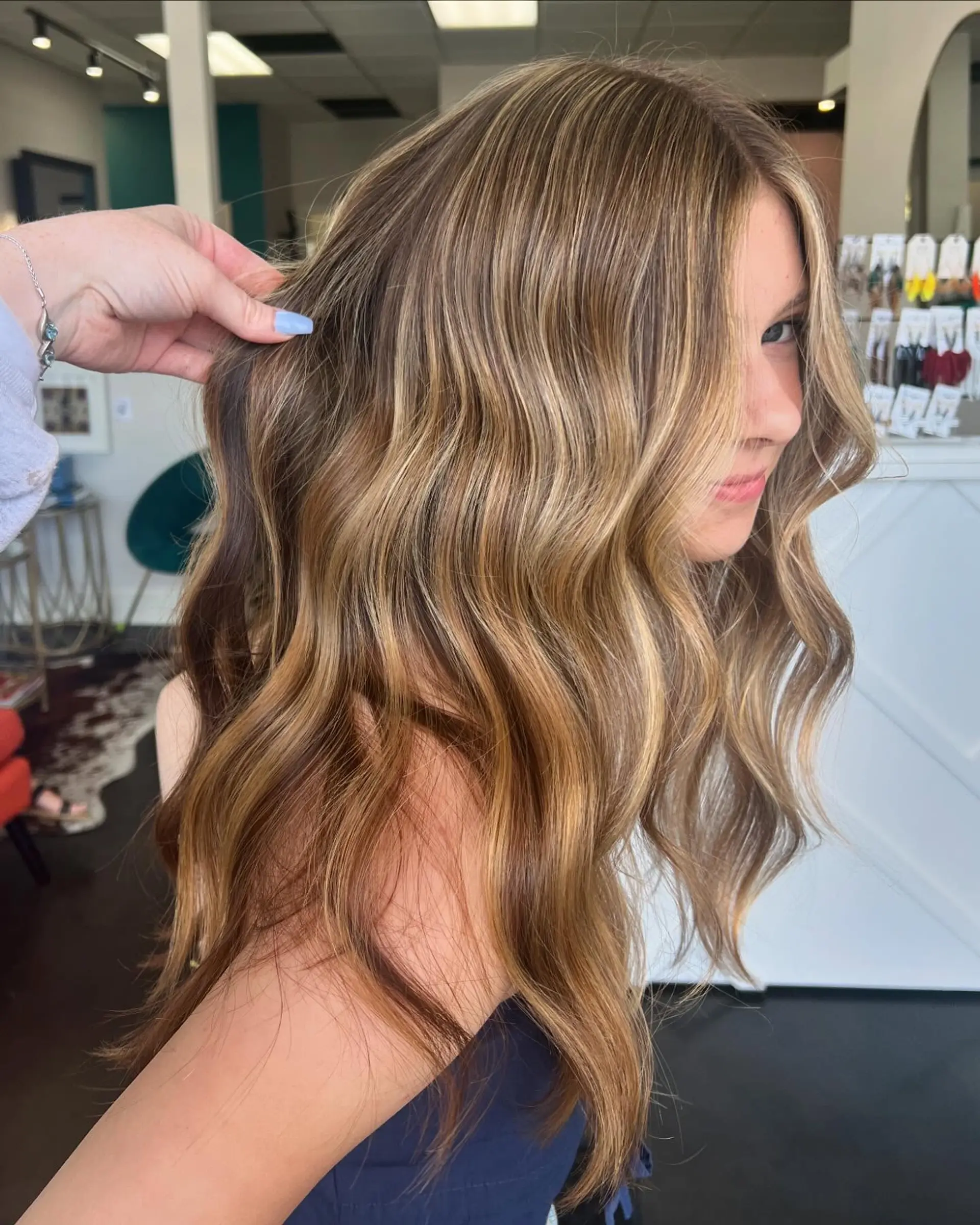 Long dimensional golden blonde balayage with soft, loose waves. 1