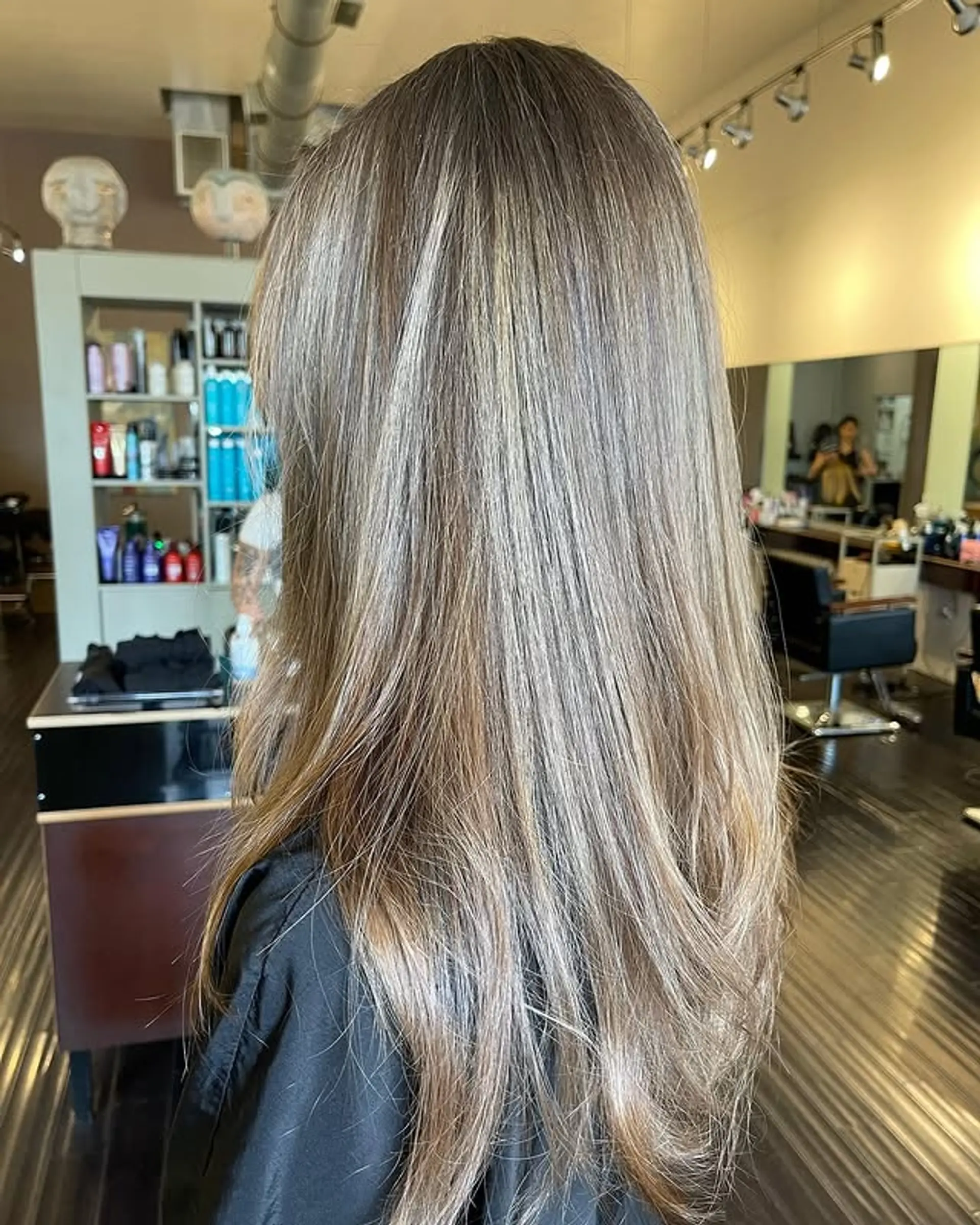 Long, straight hair with a beachy blonde balayage and subtle layers. 1