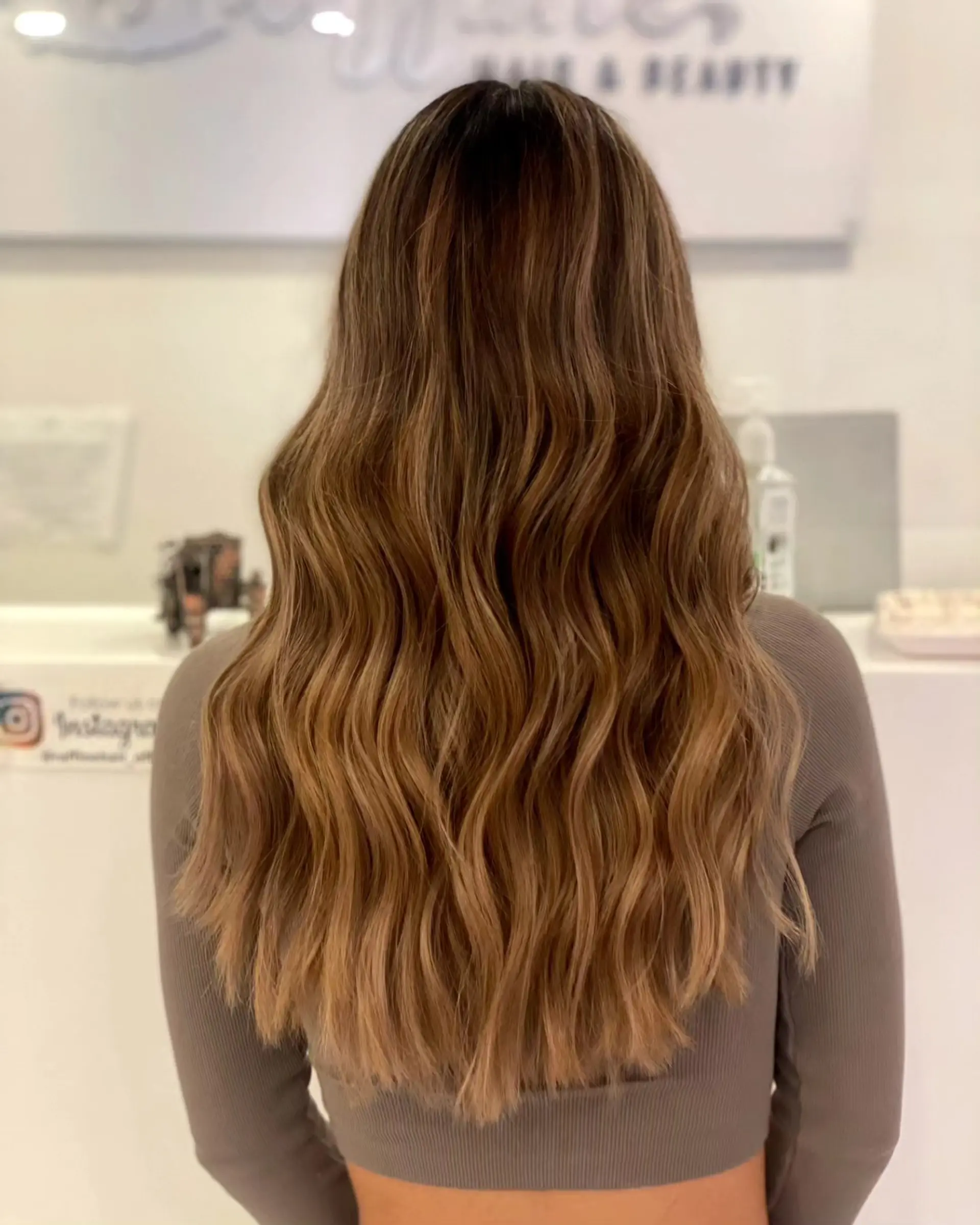 Long, flowing beige brown hair styled with soft, loose waves cascading down the back. 1