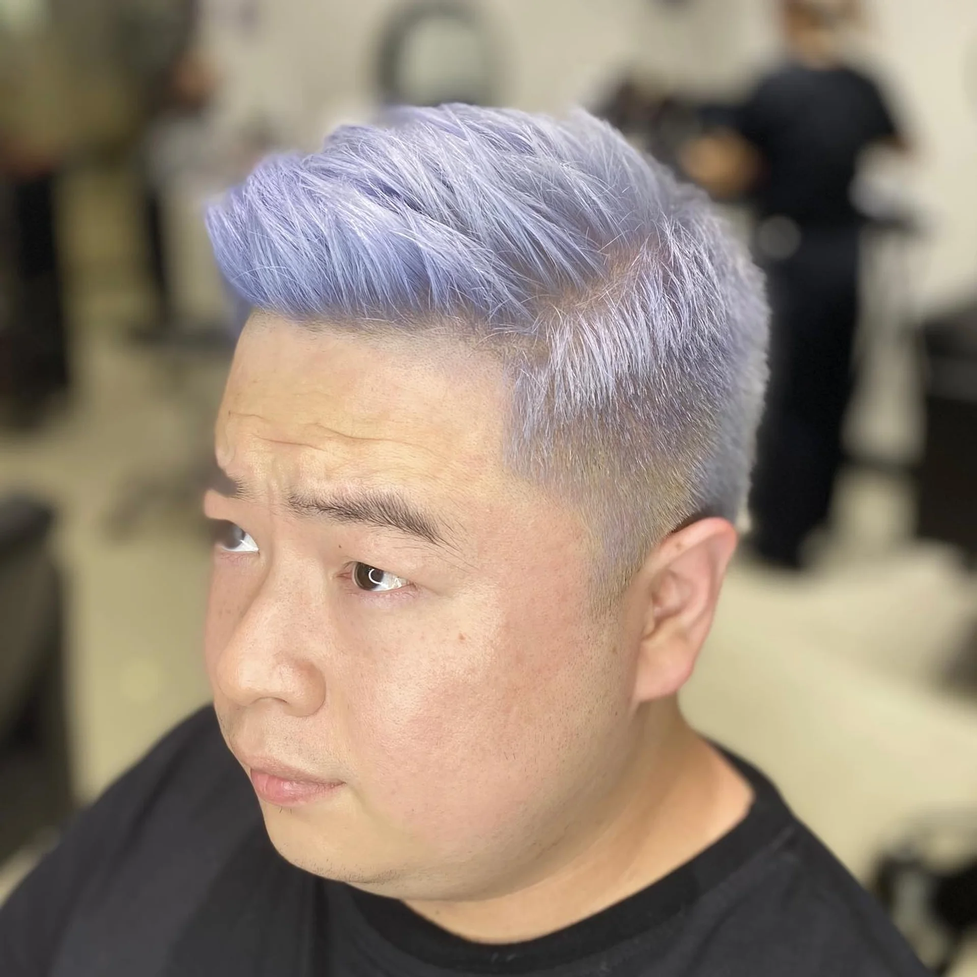 A two-block hairstyle with an ash blonde top and dark, short undercut sides, seen from the side. - Preview 1