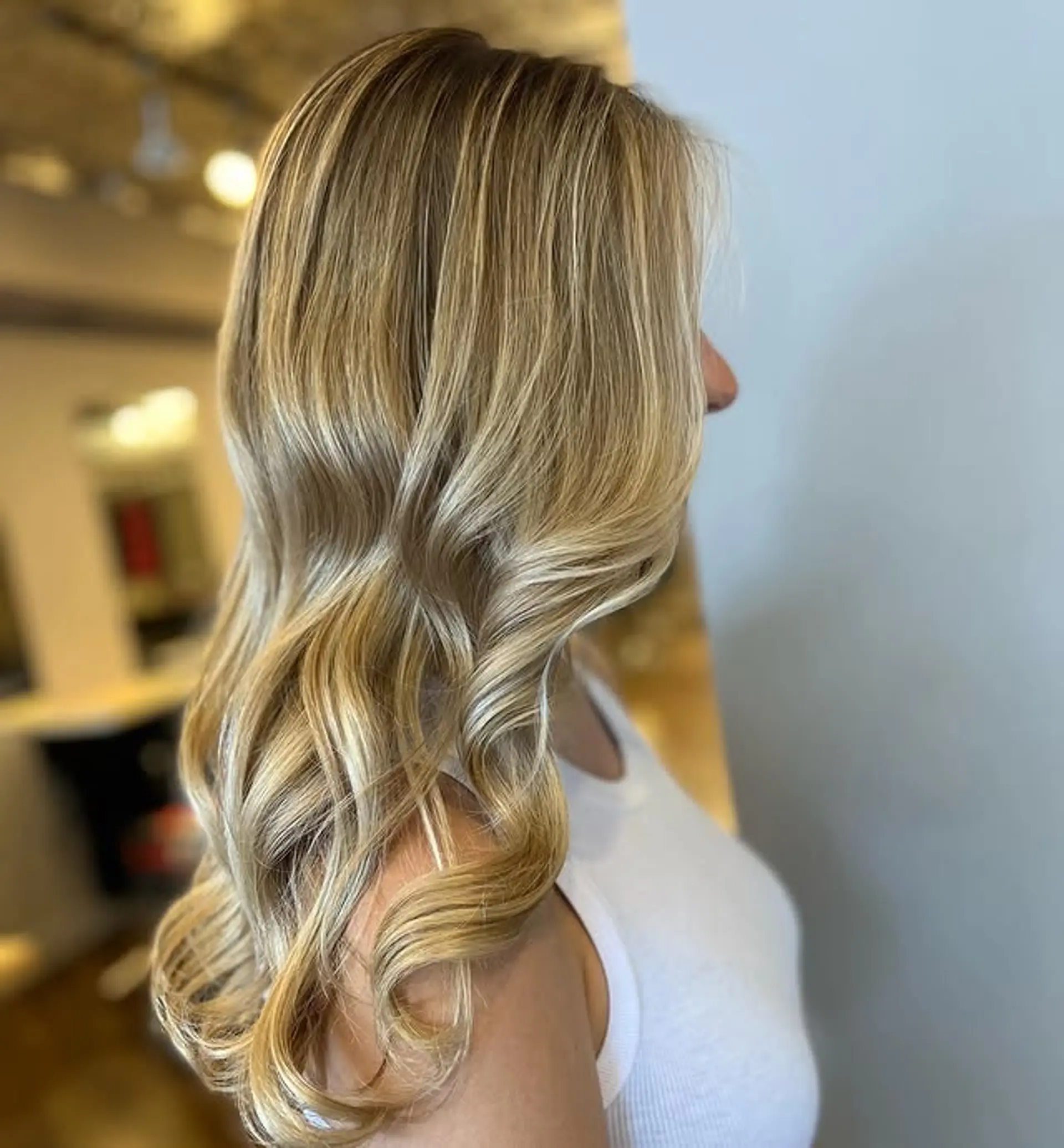 A long, wavy hairstyle with a blonde balayage and beachy waves. 1