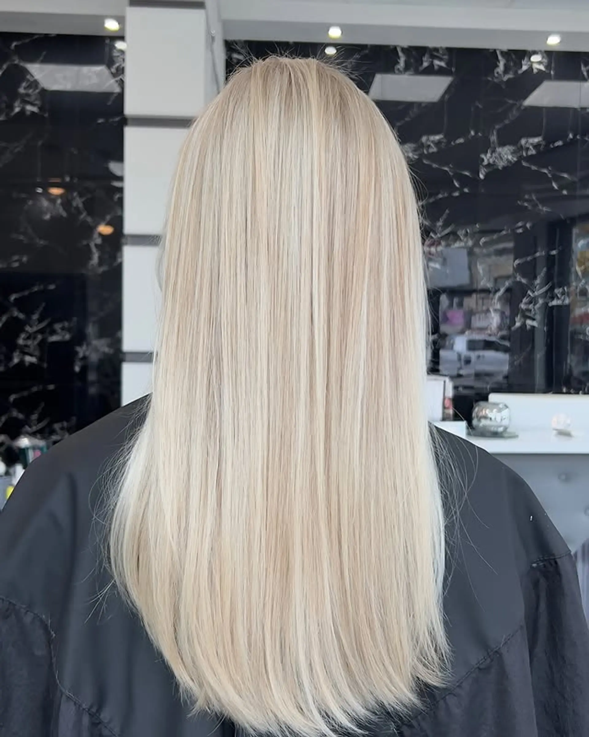 Long, straight hairstyle in an icy platinum blonde. 1