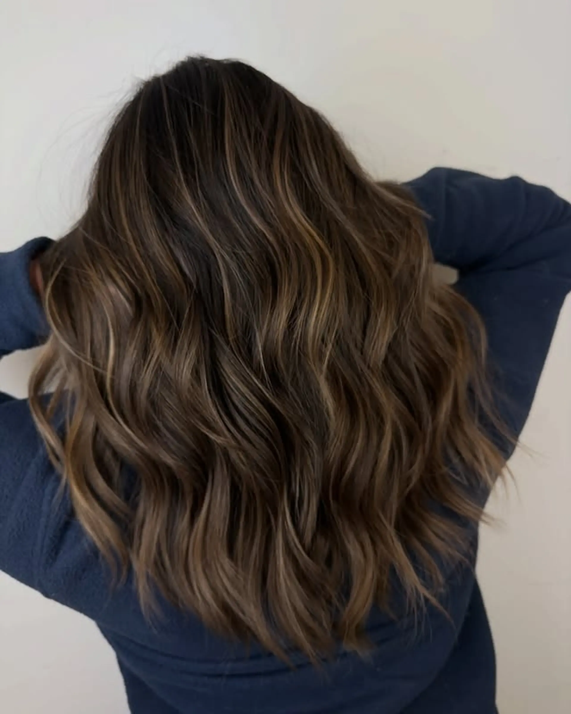 Long layered hair with balayage and beach waves. 1