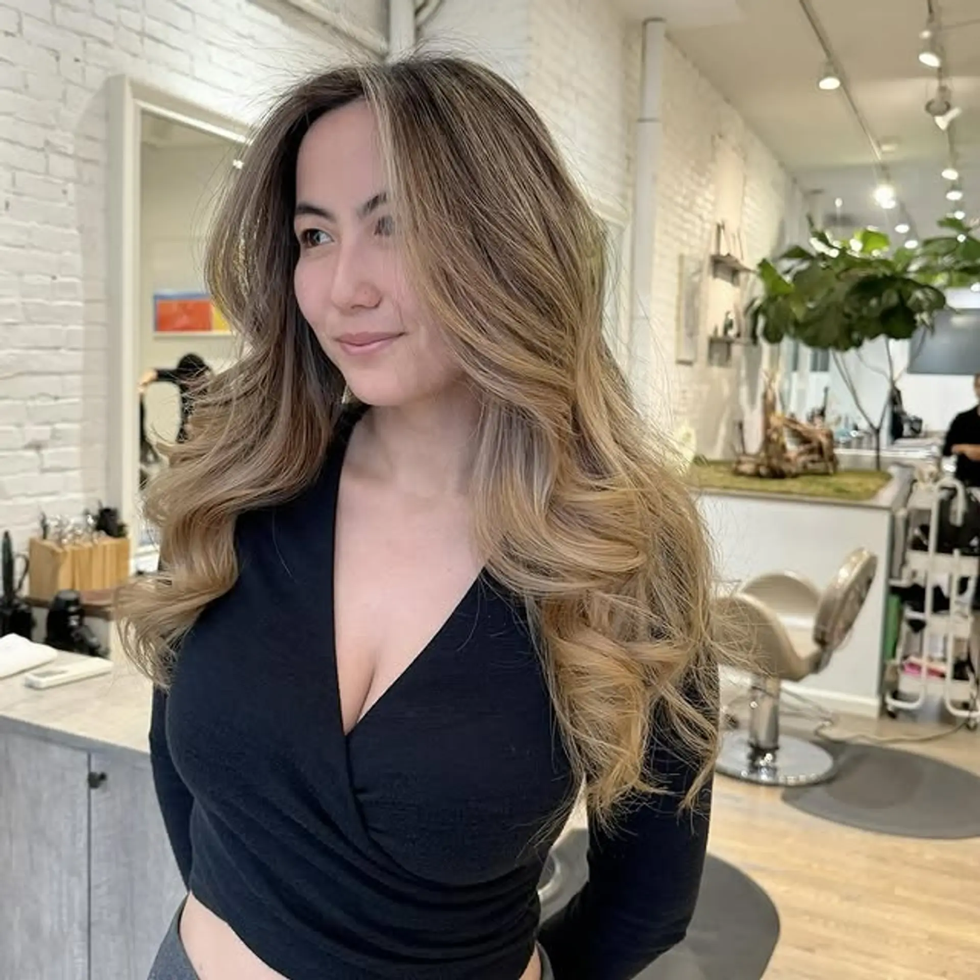 Long, wavy hairstyle with face-framing layers and soft waves. 1