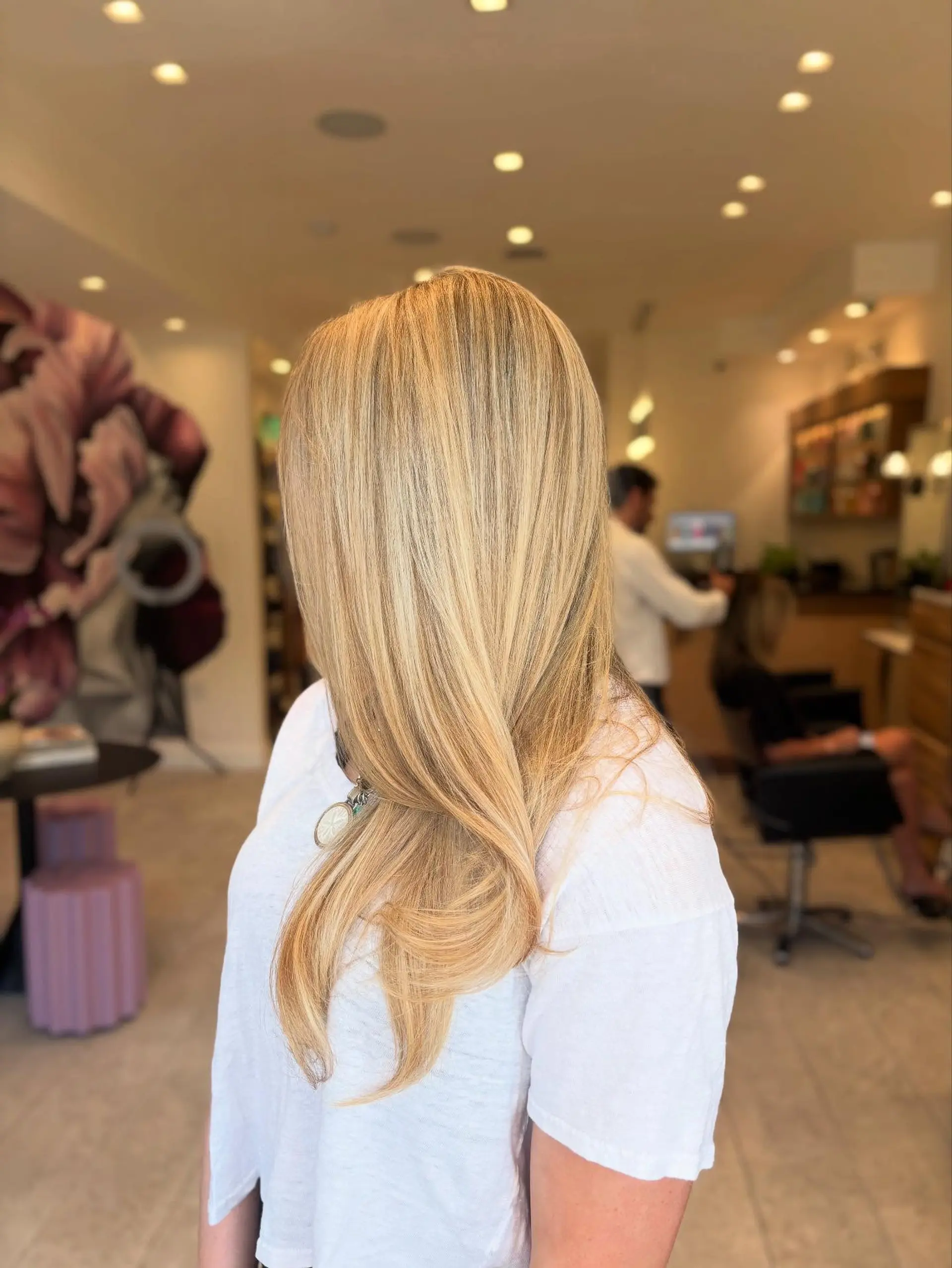 Long golden blonde hair featuring soft, multidimensional highlights with a smooth blowout finish. 1