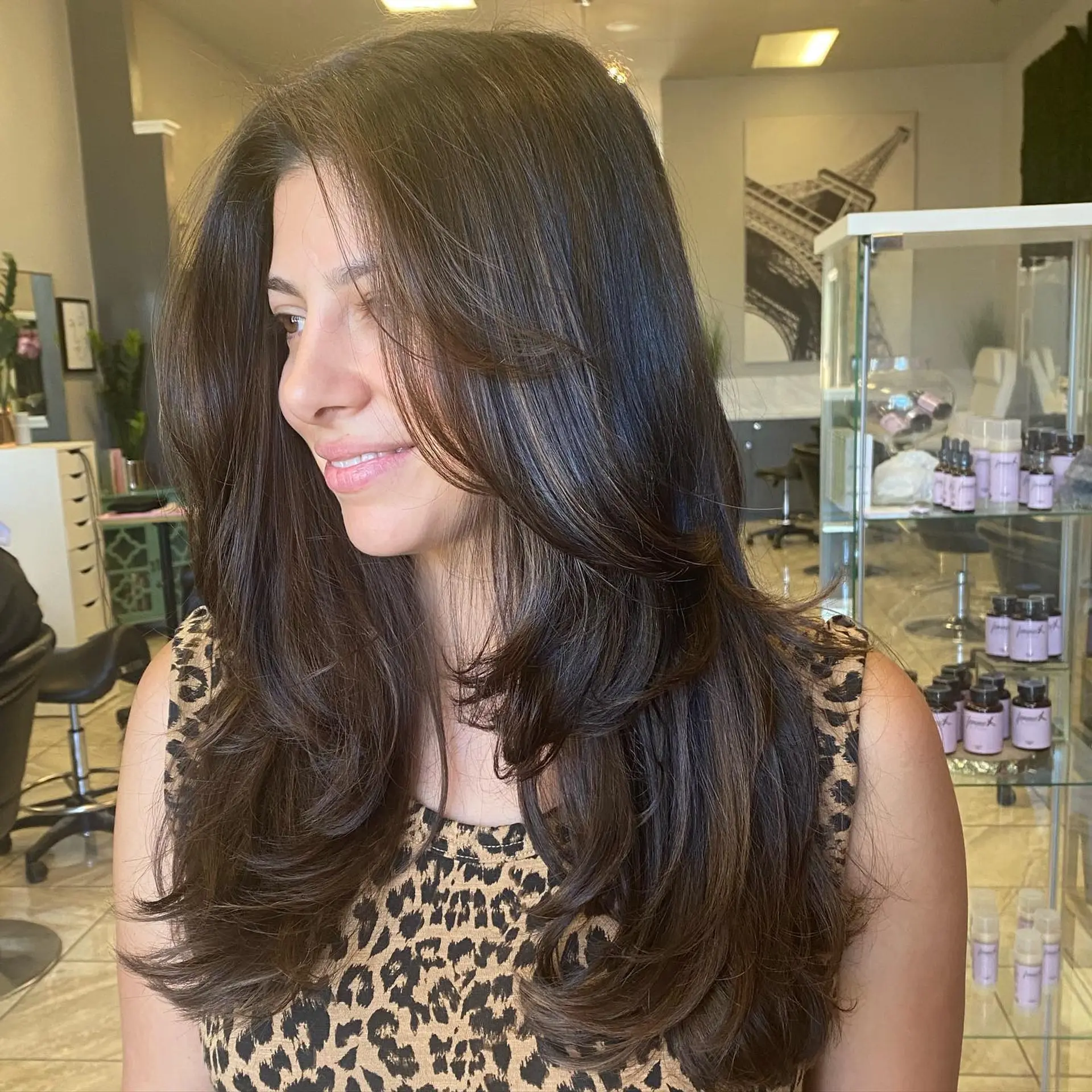 A long, layered haircut with face-framing layers, styled with a soft blowout. 1