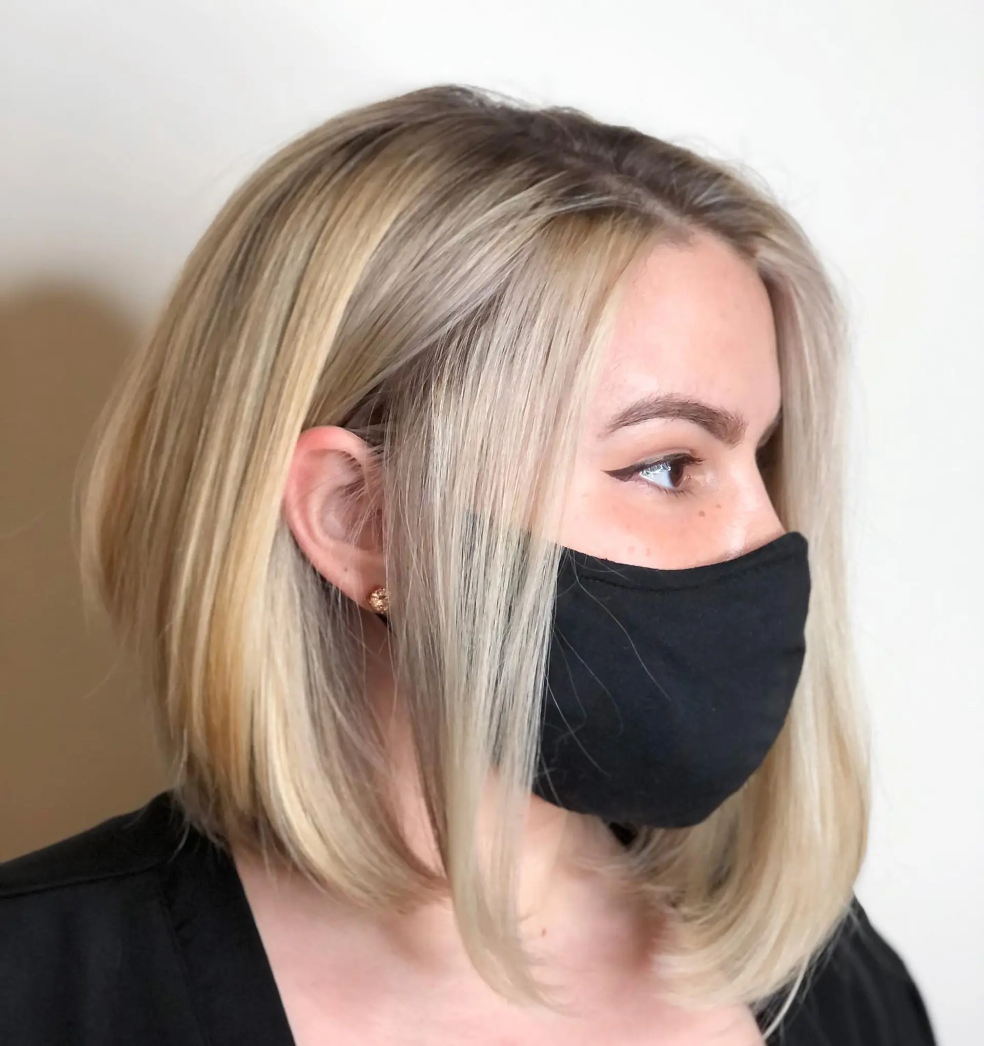 A sleek, angled blonde bob with subtle layers and soft under-turned ends framing the jawline. 1