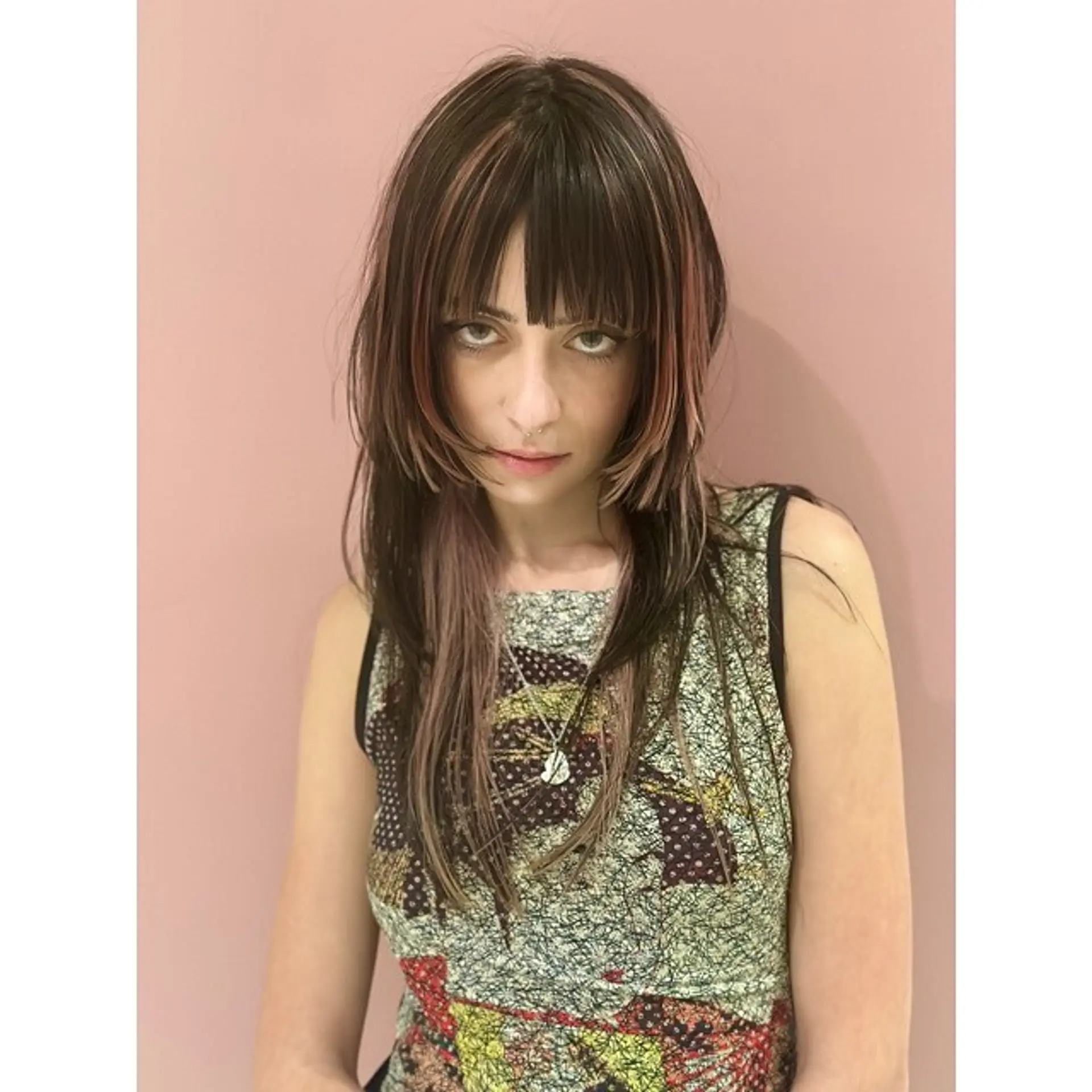 A modern shag with blunt baby bangs, face-framing layers, and dimensional coloring. 1