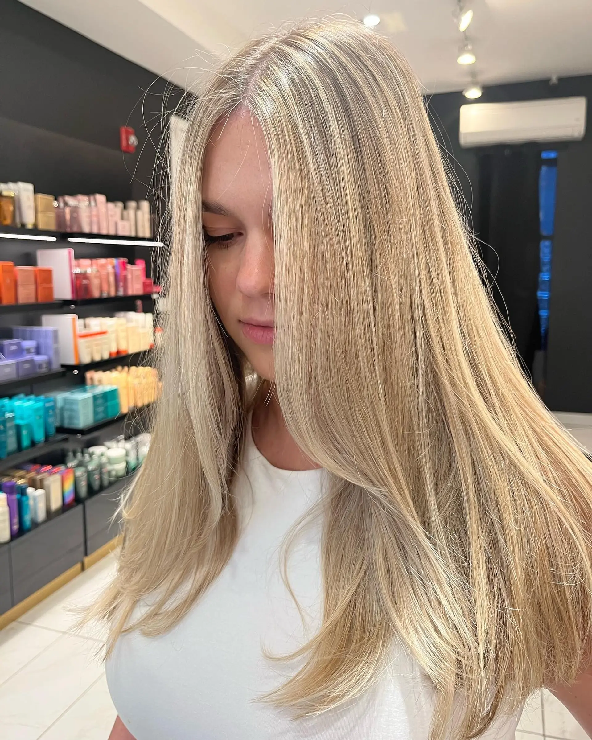 Long, straight hair with layers and a face framing style. 1