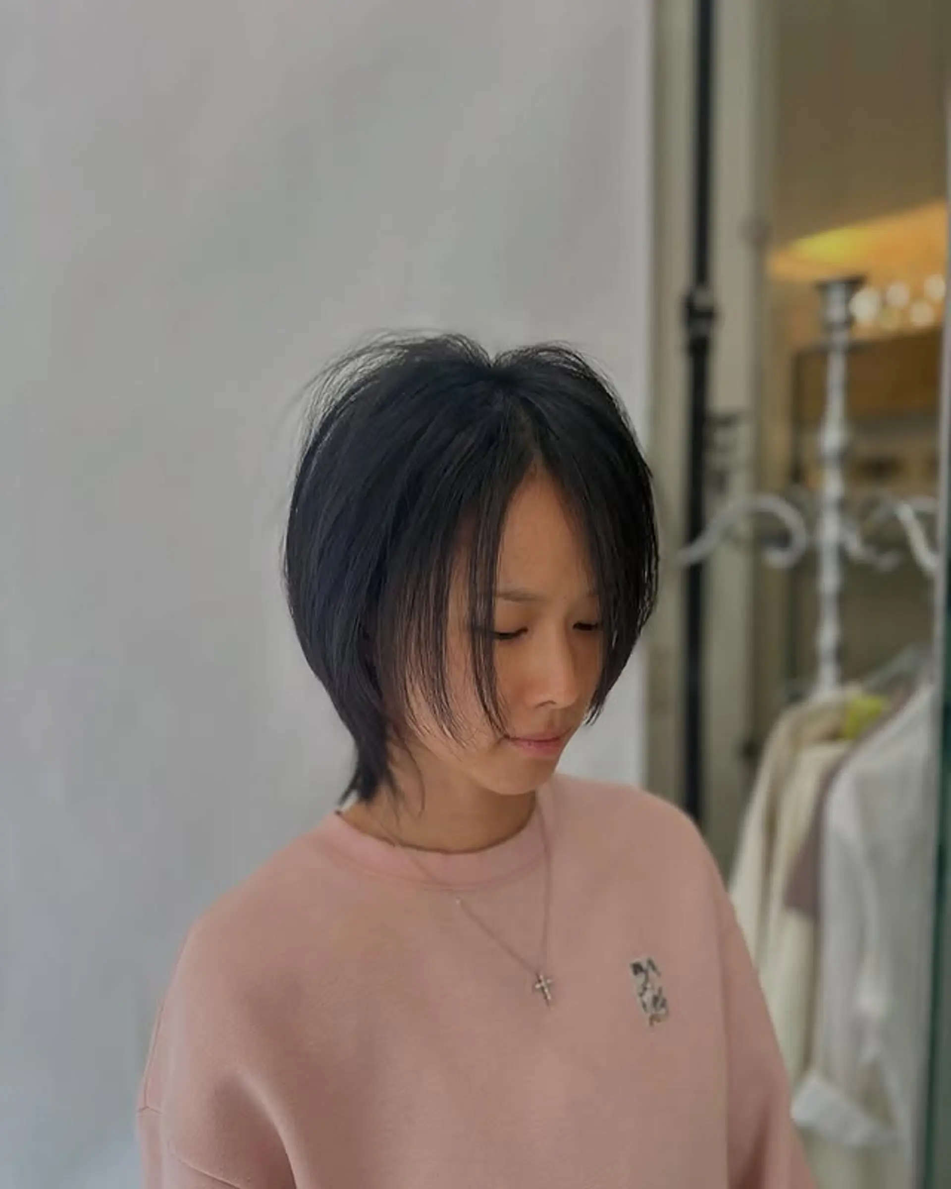 A modern shaggy bob with choppy layers and wispy bangs that frame the face. 1