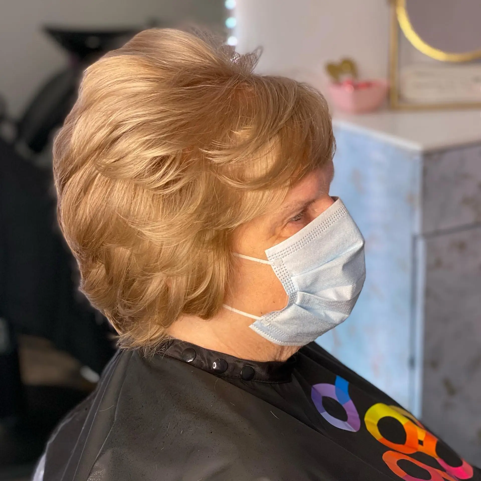 A bouncy, voluminous layered bob featuring soft waves and a rounded shape, offering a timeless and elegant look with ample body. 1