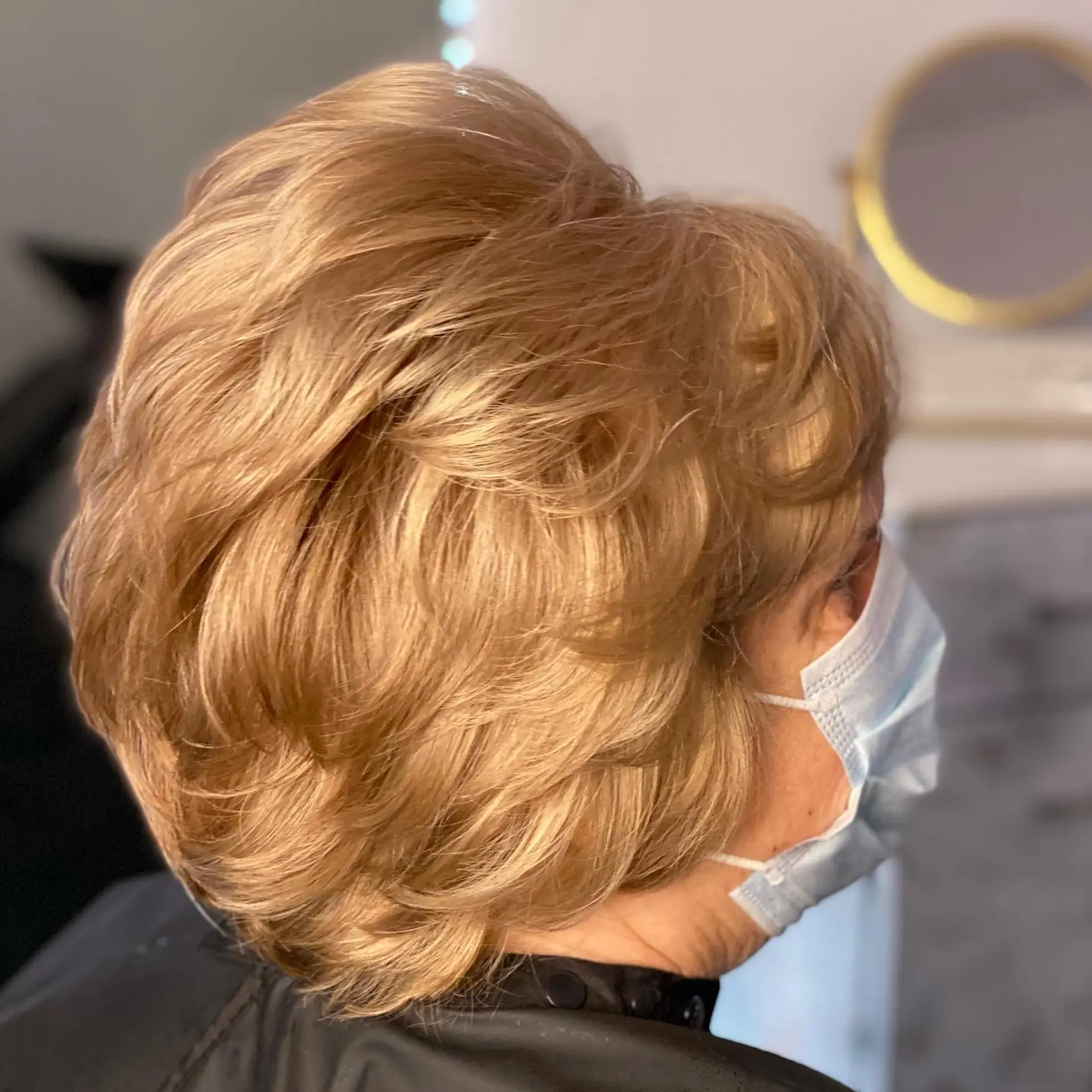 A bouncy, voluminous layered bob featuring soft waves and a rounded shape, offering a timeless and elegant look with ample body. 2