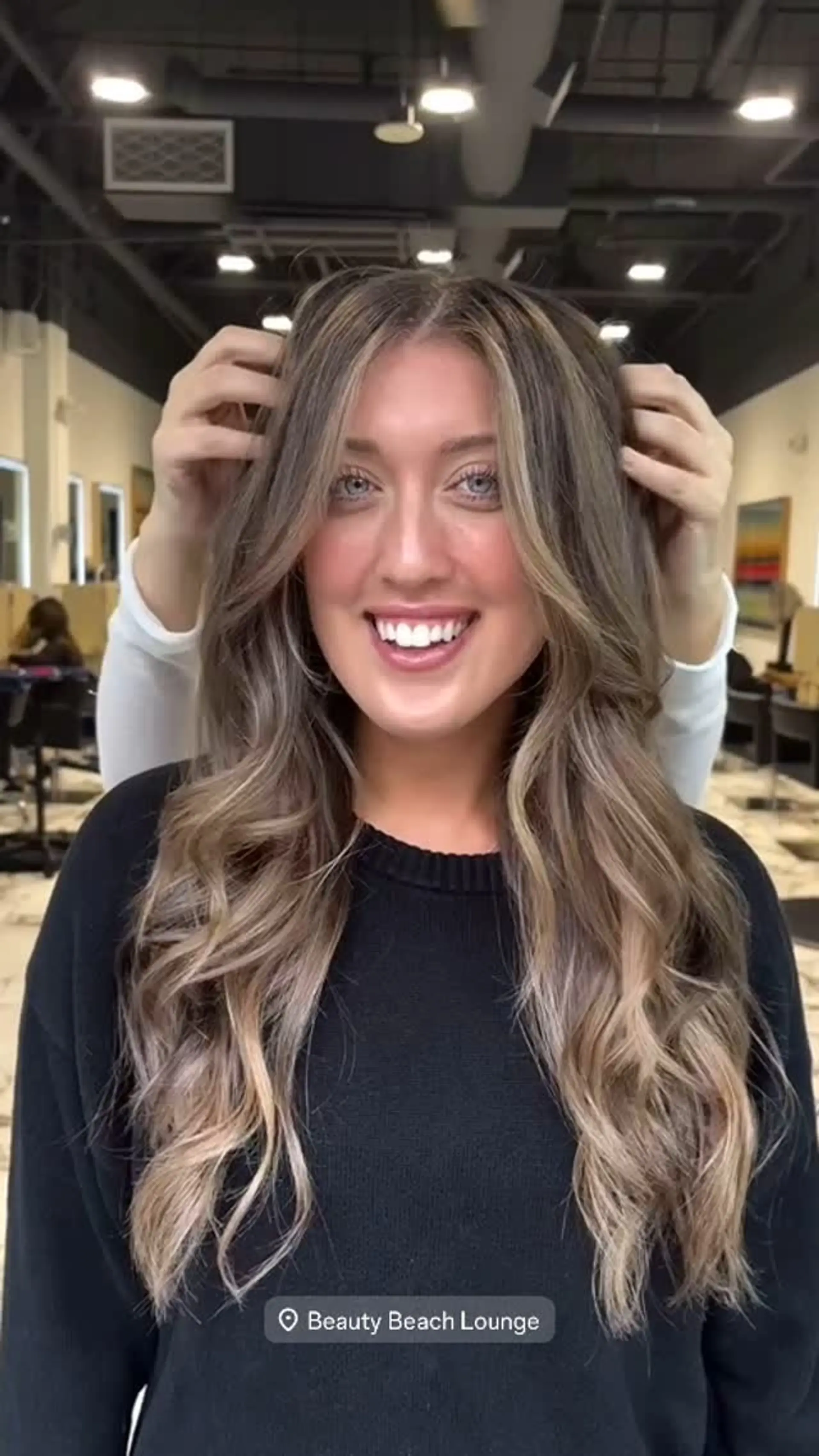 Long bronde hair styled in loose, voluminous waves featuring a bright face-framing money piece and seamless dimensional highlights. 1