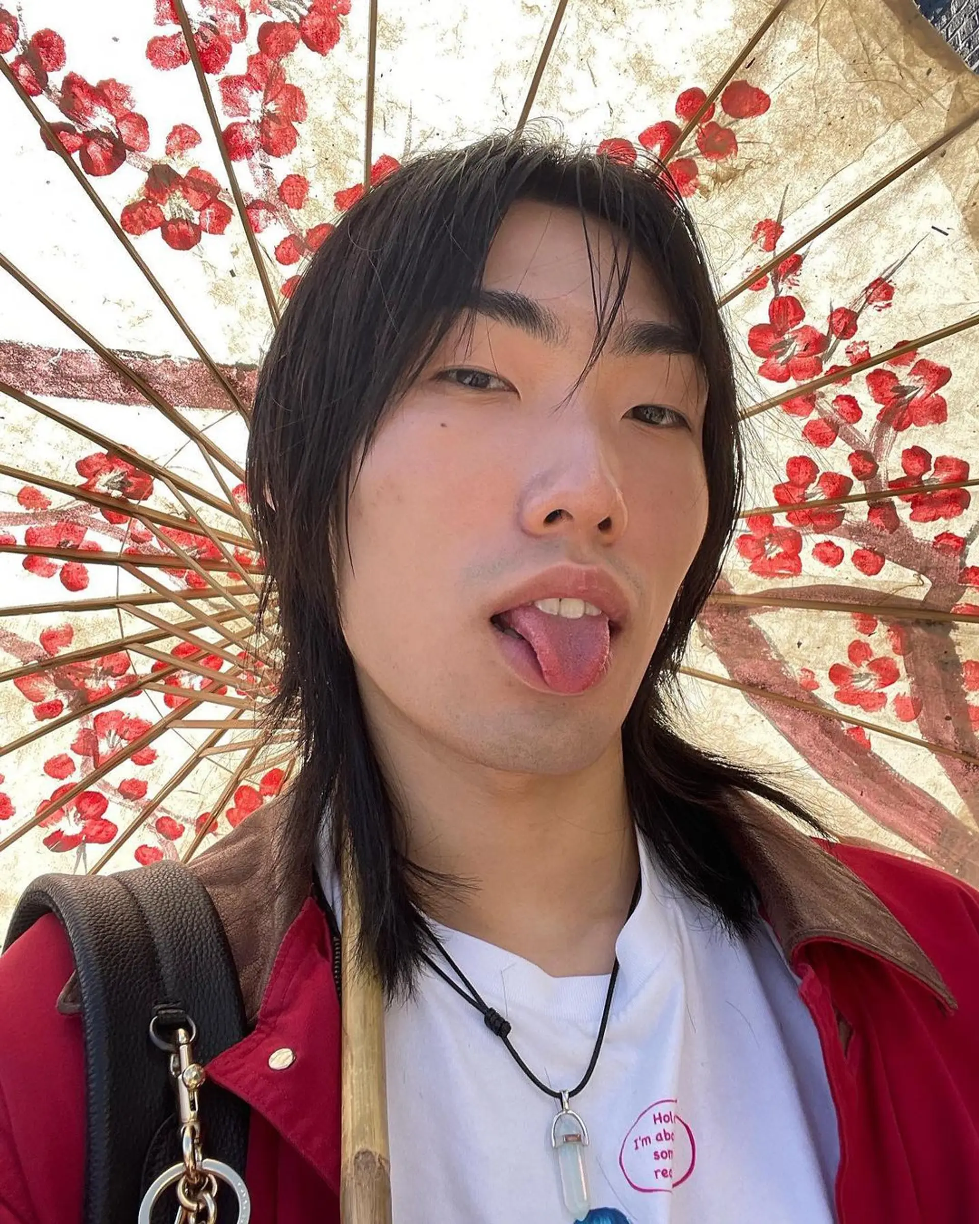 A medium length, straight hairstyle with black layers that cascade around the face, evoking movement and casual elegance. 1