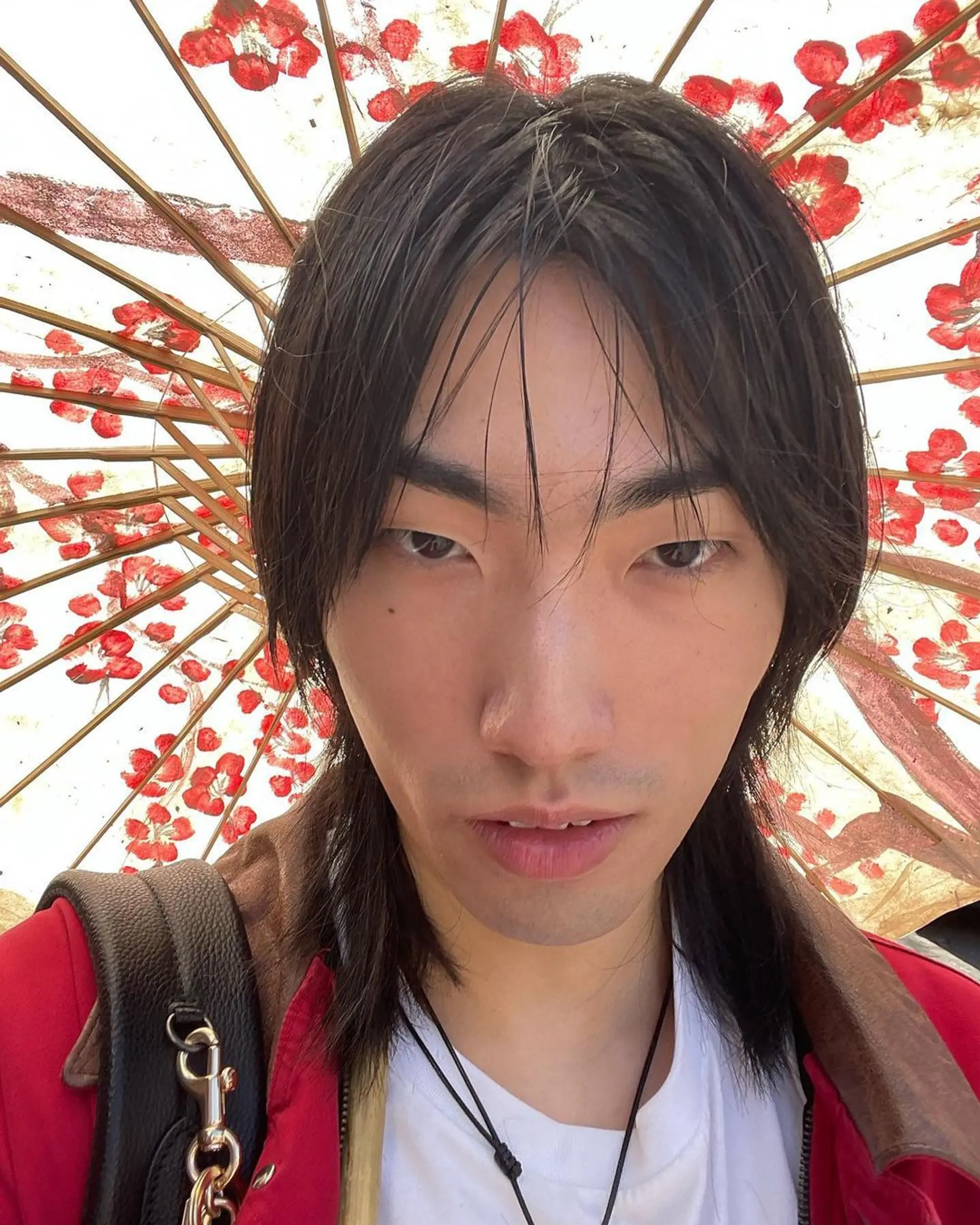 A medium length, straight hairstyle with black layers that cascade around the face, evoking movement and casual elegance. 2