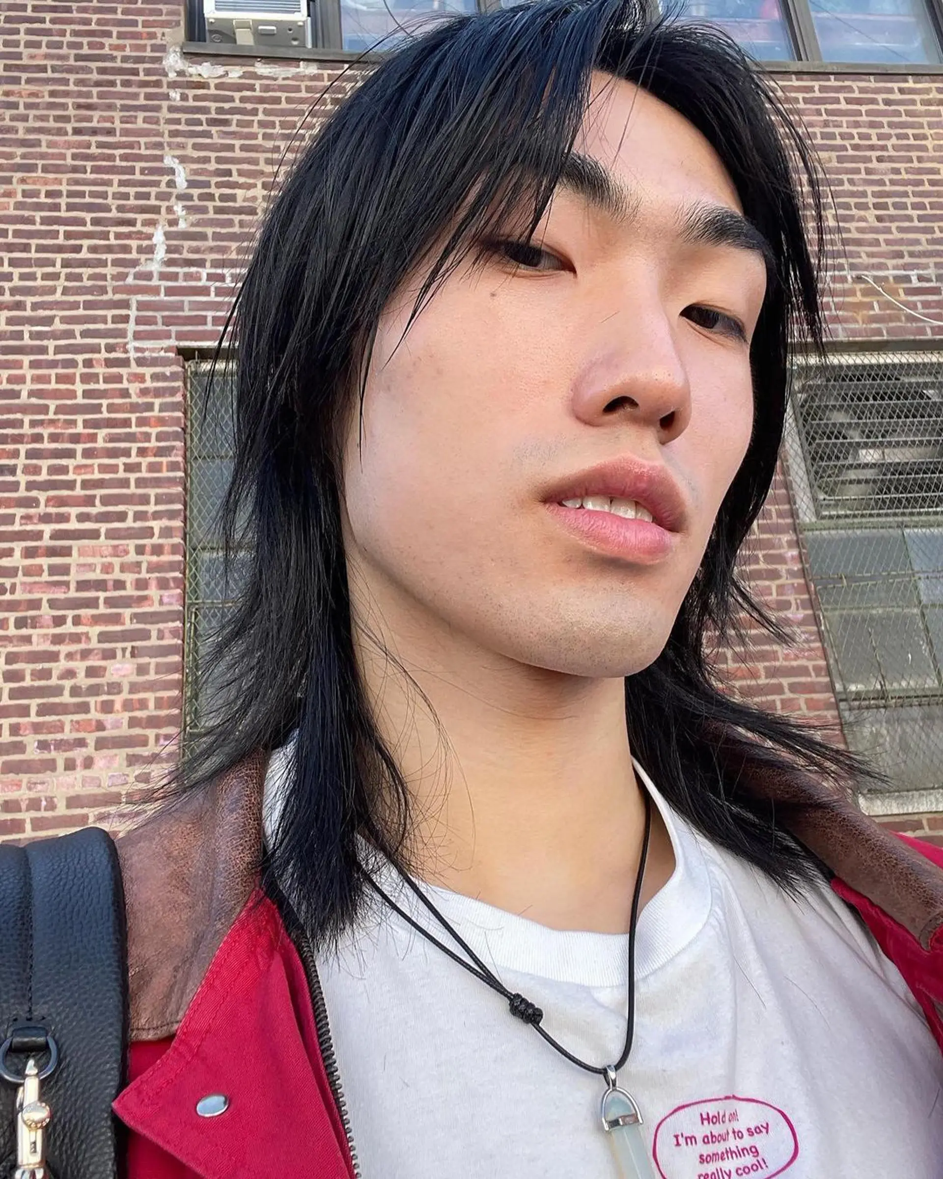 A medium length, straight hairstyle with black layers that cascade around the face, evoking movement and casual elegance. 3