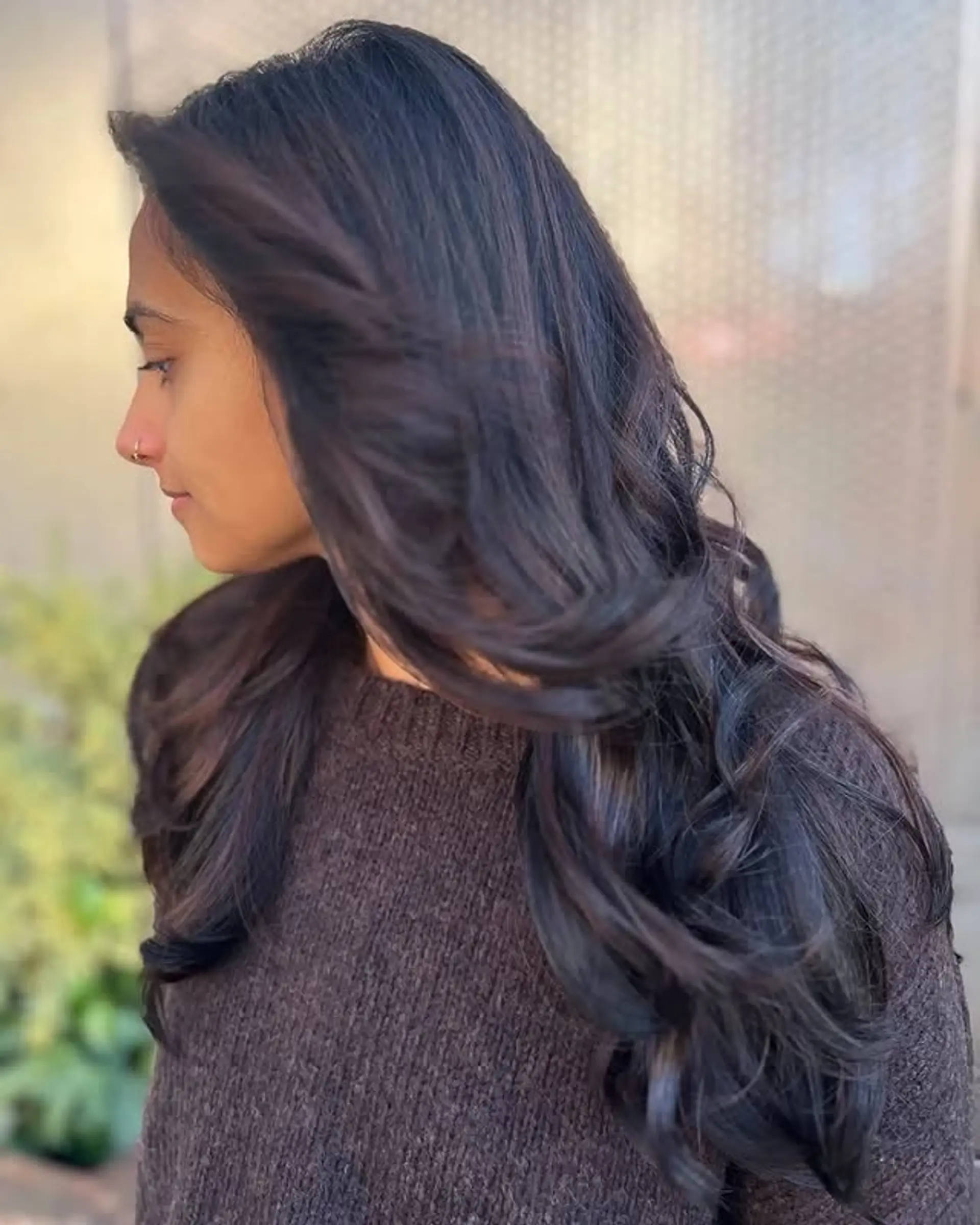 A long, layered hairstyle with a V cut to create dimension and movement. 1