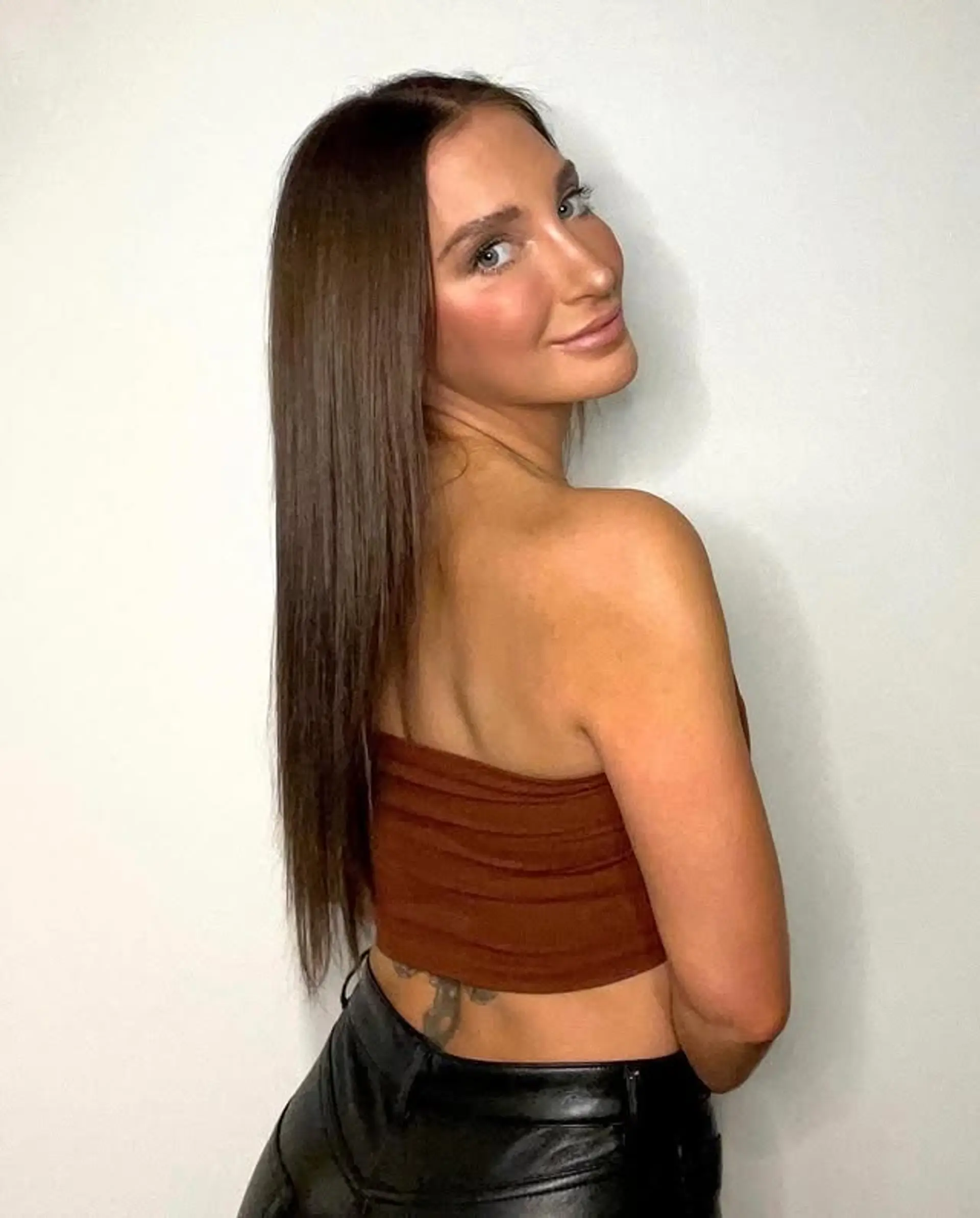 Long, straight brunette hair with a sleek finish. 1