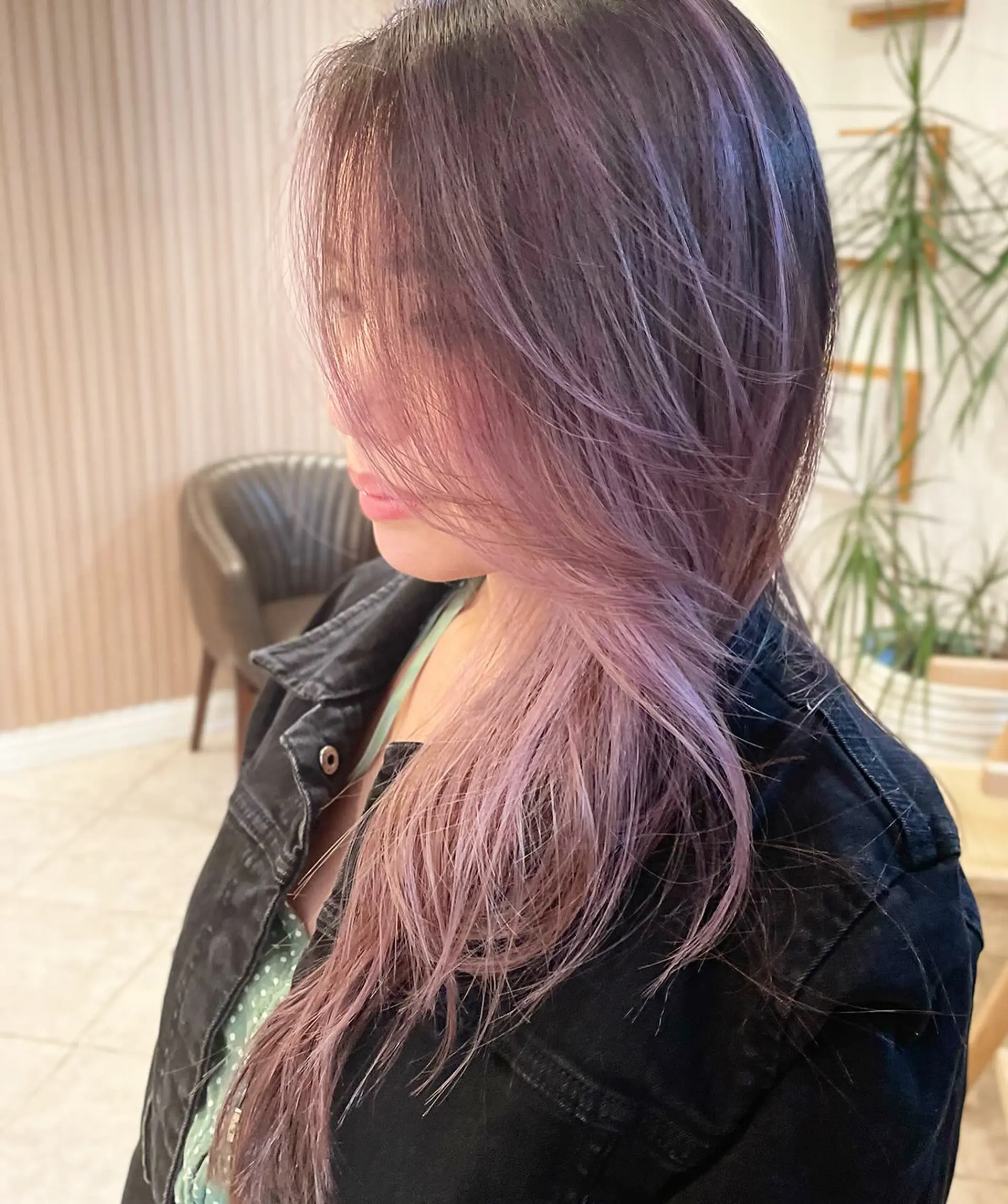 Long layered cut featuring soft, dimensional smoky lavender highlights blended seamlessly into a deep brunette base. 1