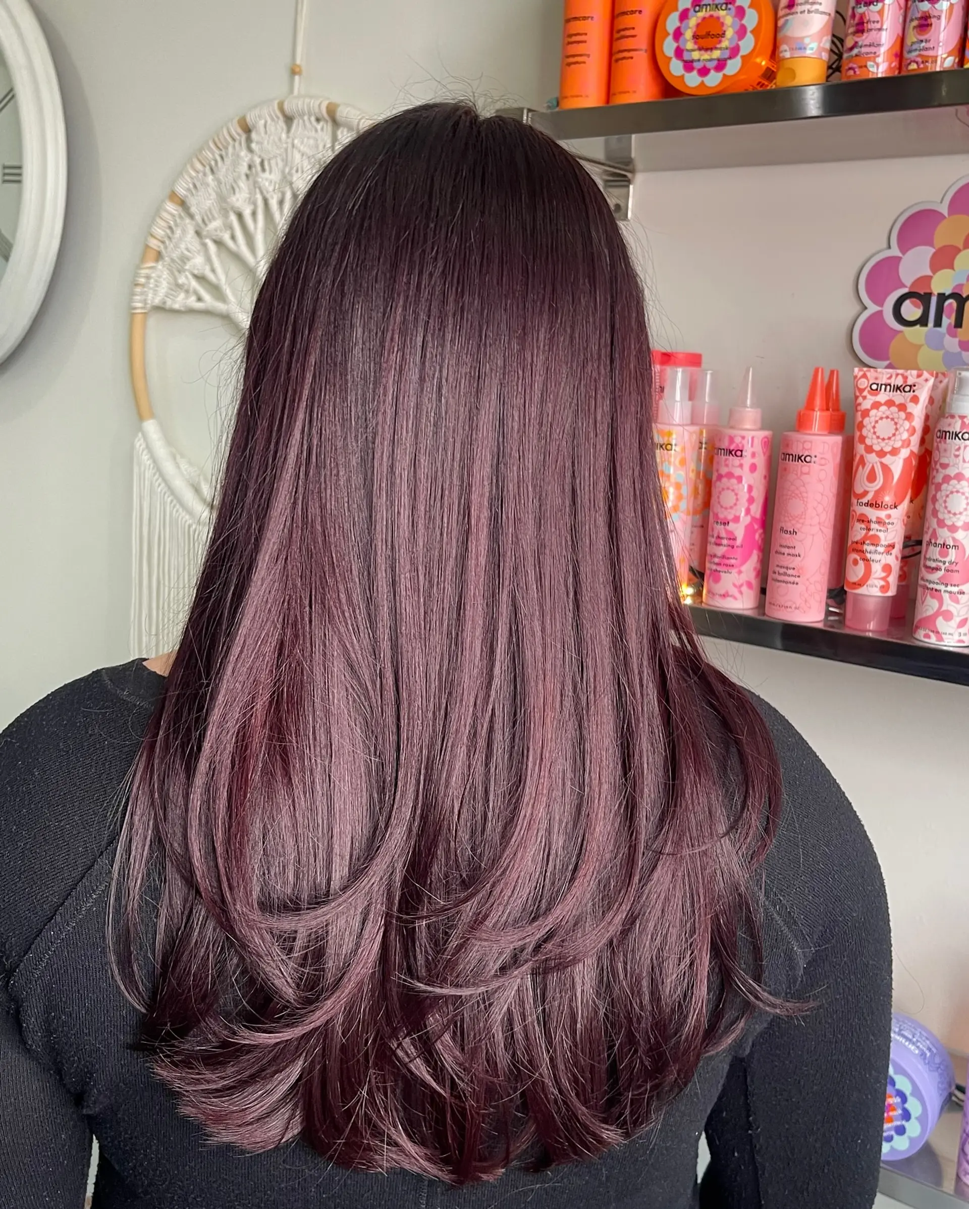 Long deep mahogany hair featuring soft, face-framing and back layers styled with smooth curved ends. 1
