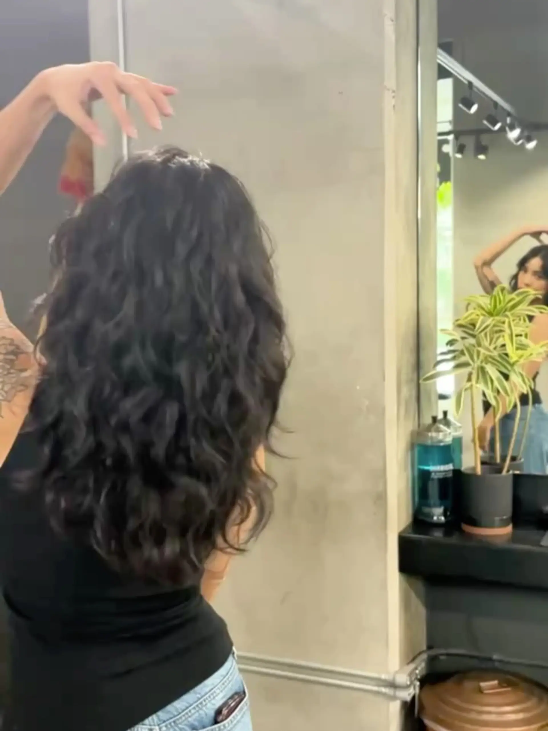 Long, dark wavy hair cut with soft cascading layers for movement and natural texture. 1