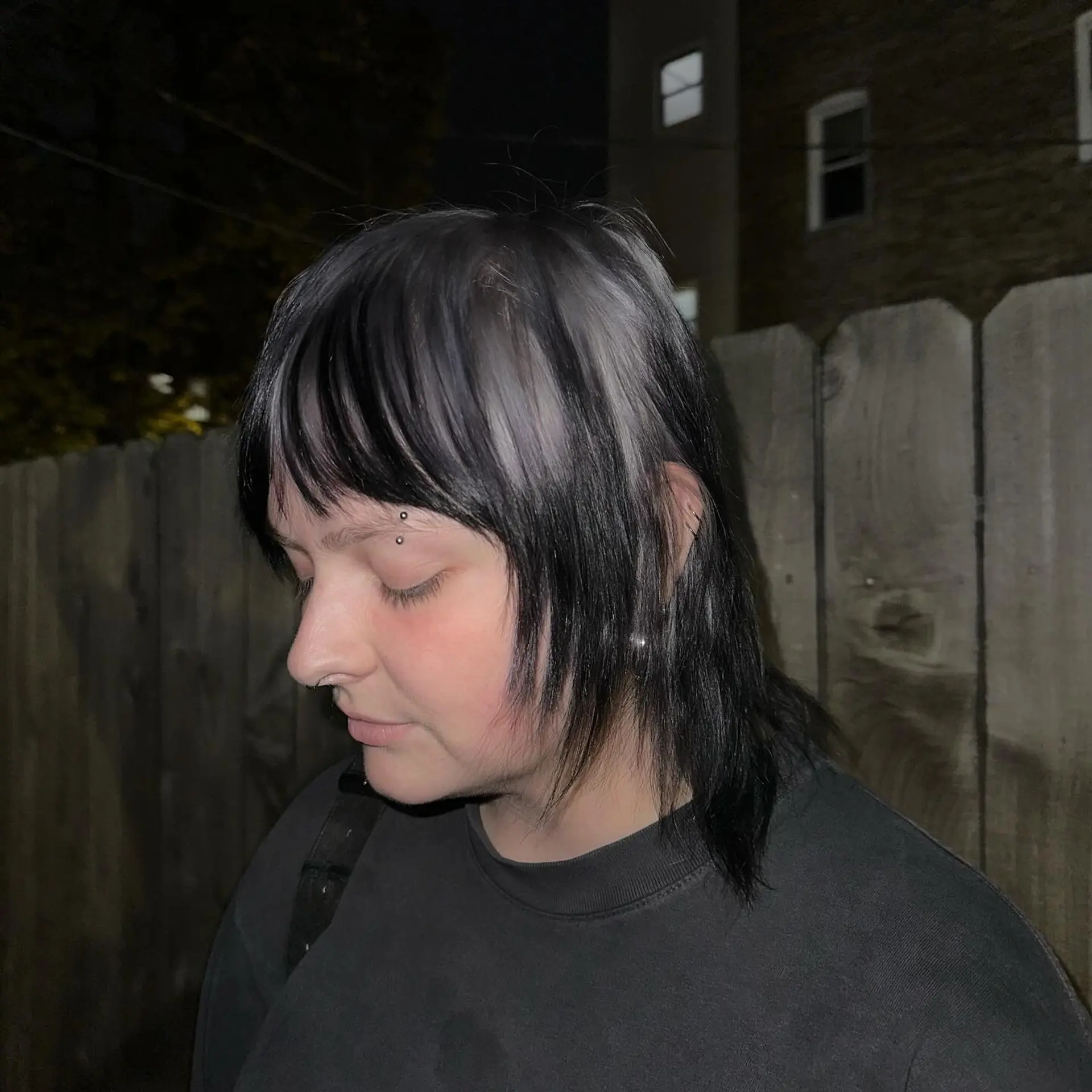 This trendy, medium-length hairstyle features a modern mullet cut with a bold two-tone color contrast. 4