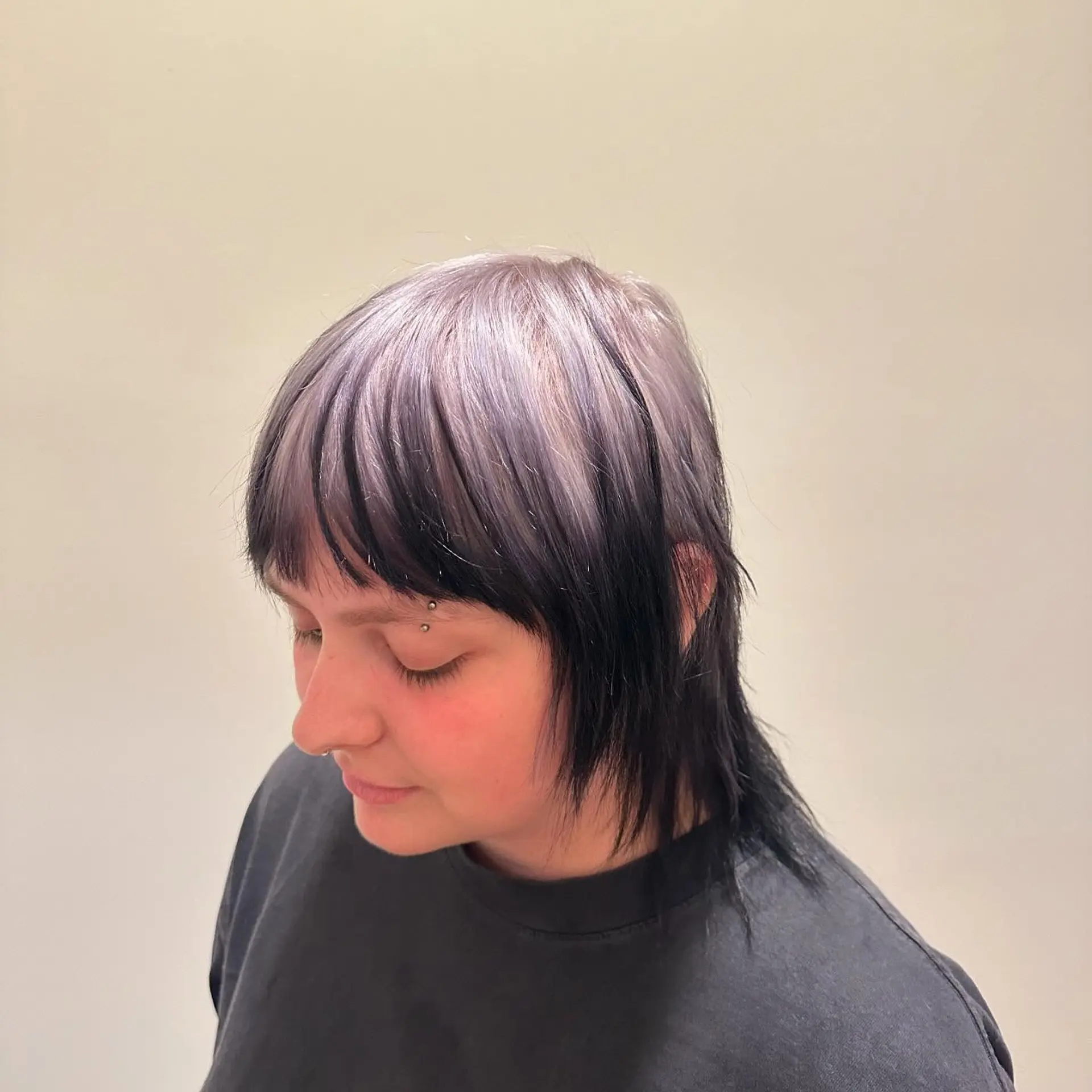 This trendy, medium-length hairstyle features a modern mullet cut with a bold two-tone color contrast. 5