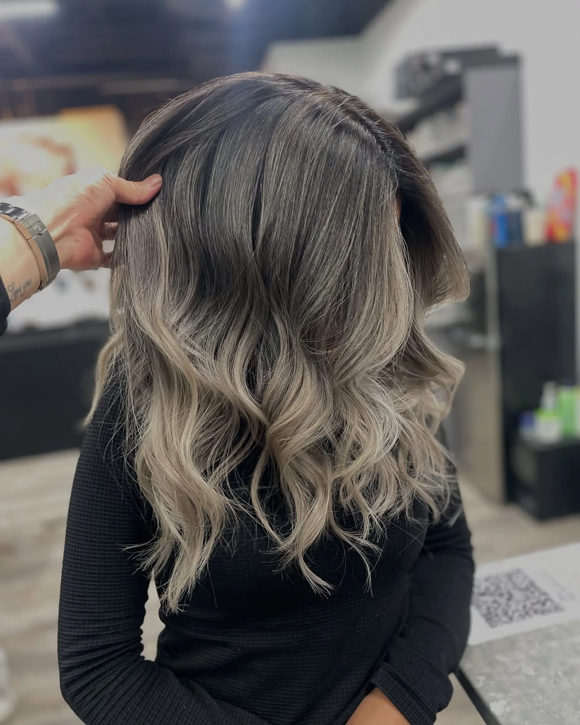 A long, wavy hairstyle with a blended ash blonde balayage. 1