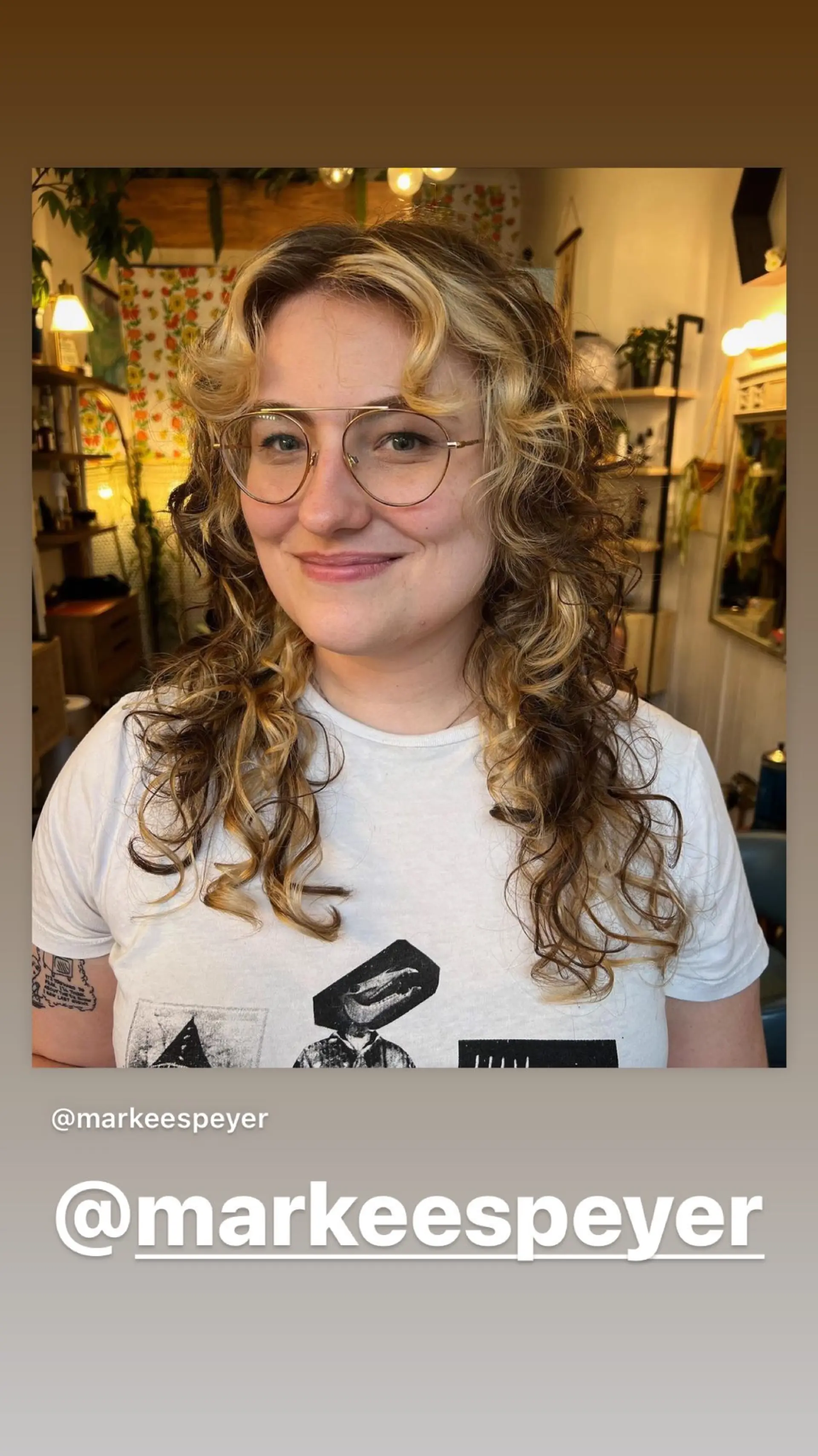 A textured wolf cut with lots of layers and curly curtain bangs. Bronde color. 1