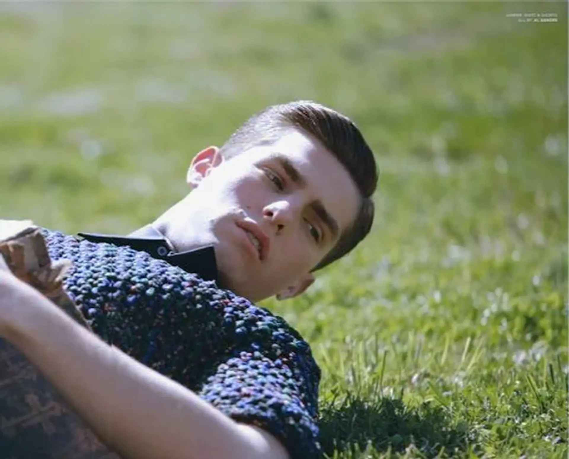 A sleek and glossy hairstyle with a precise side part, showcasing a retro-inspired look. 1