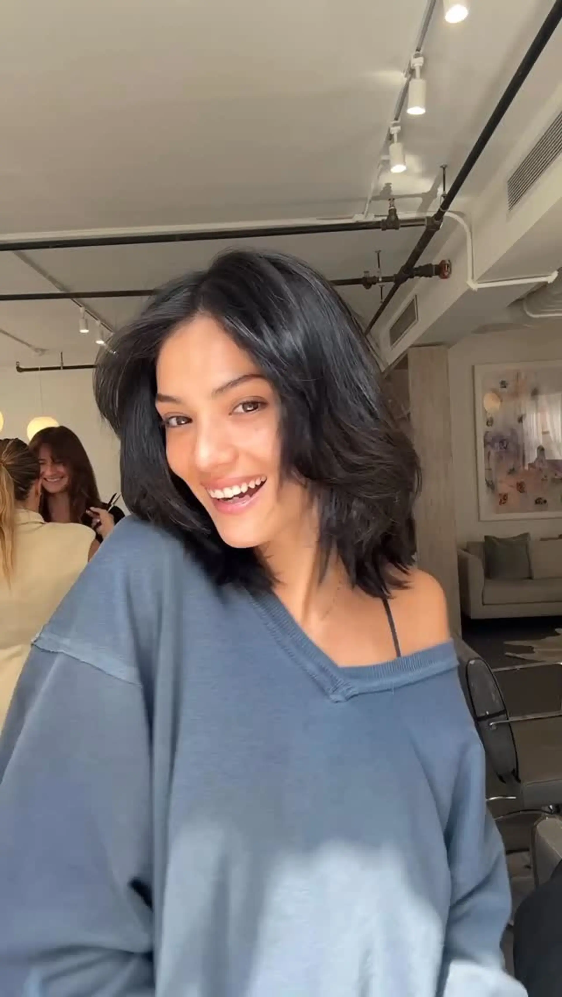 A shoulder-length layered lob dyed a rich dark espresso hue, styled with soft volume and face-framing feathered layers. 1