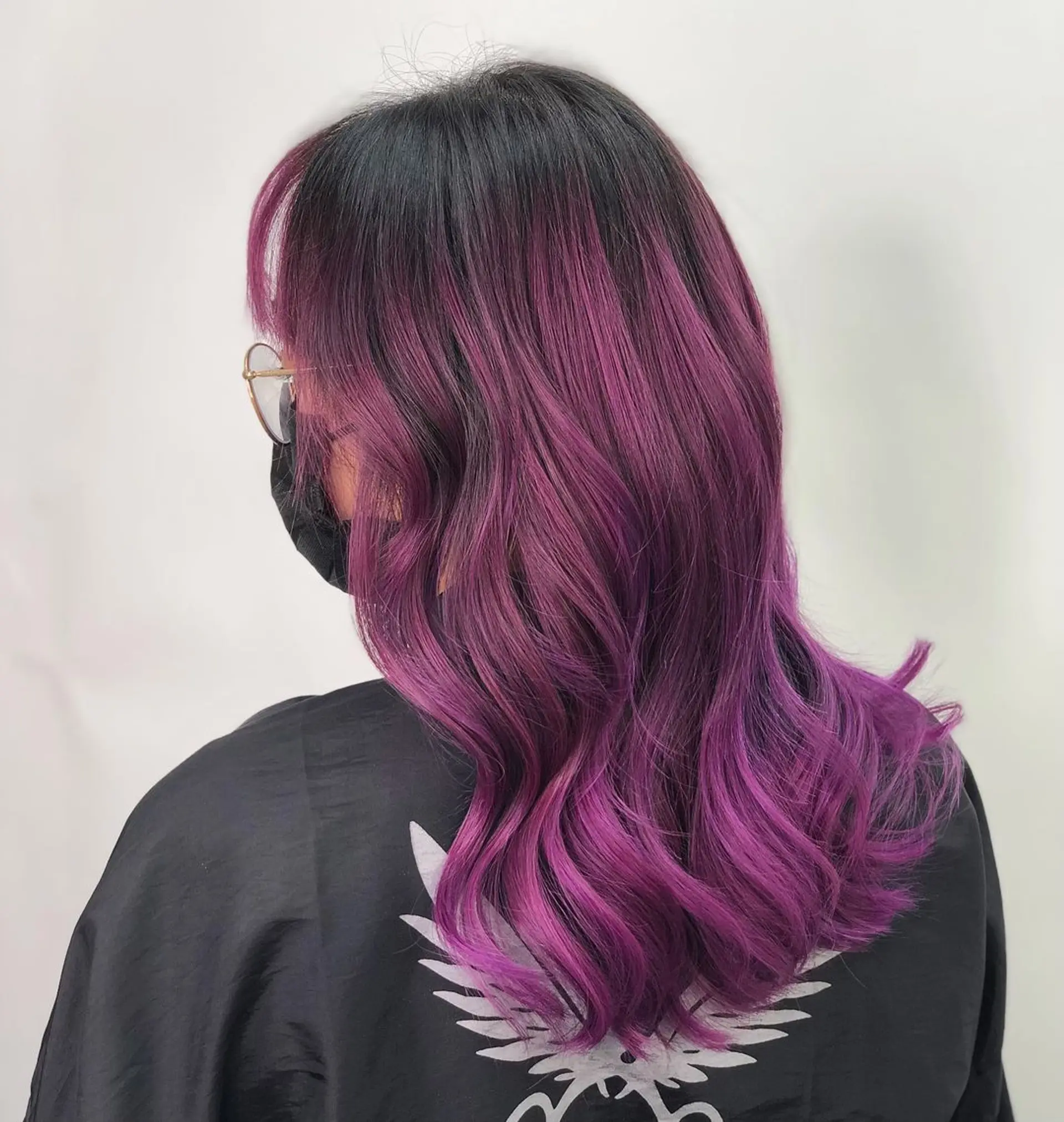 Medium-length black to Purple ombre hair with soft waves, layered cut, and face-framing bangs.
Stylist - @xcellent_jason 1