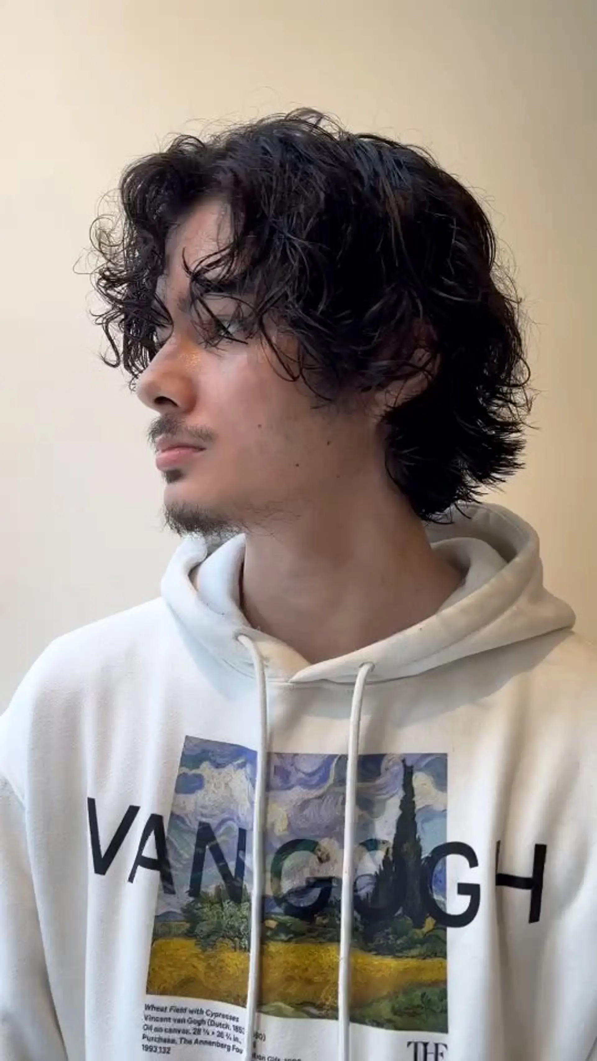A textured medium-length men's cut with natural waves and piecey volume. 1