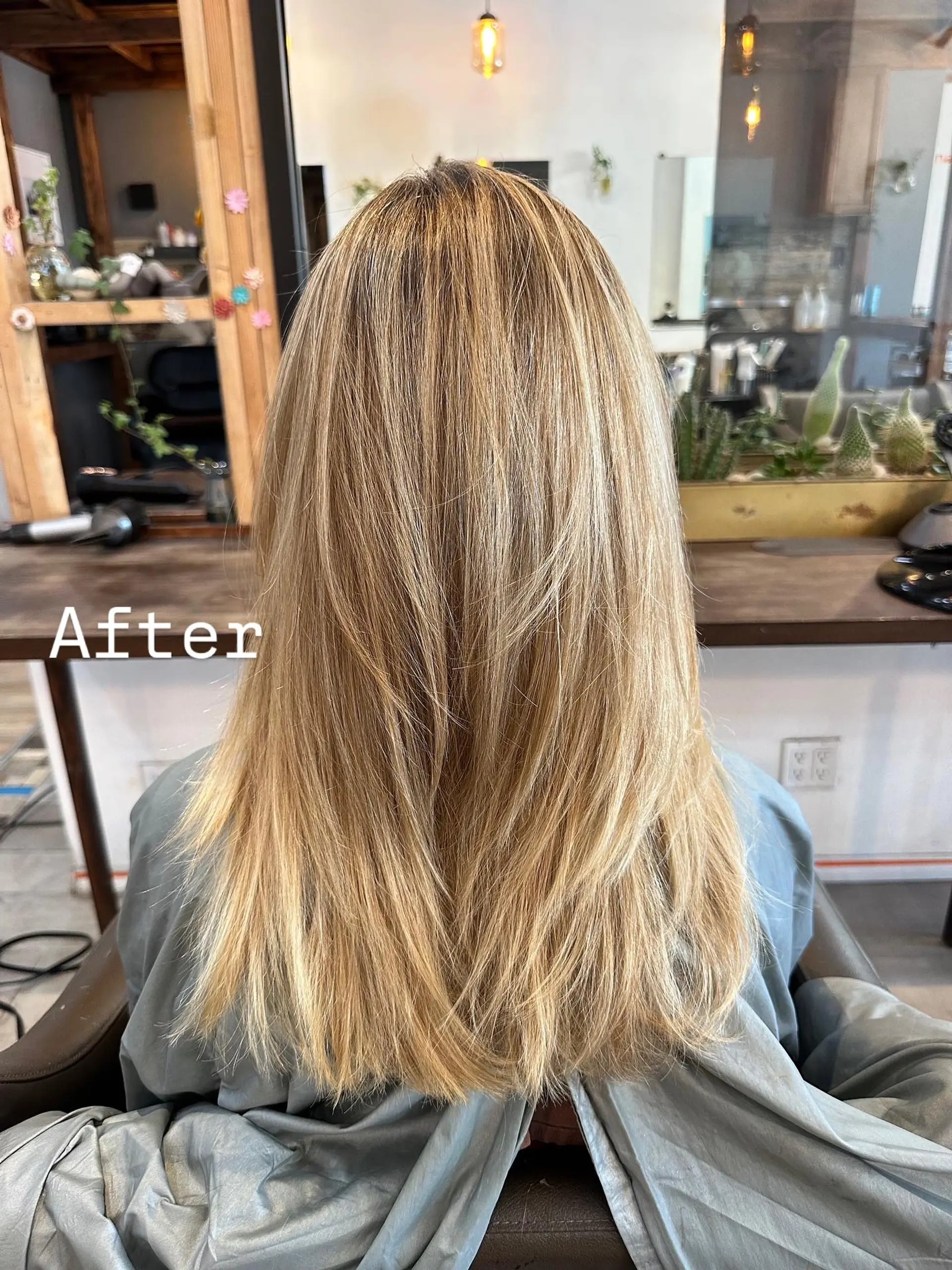 Long, layered hairstyle with face-framing layers. 1