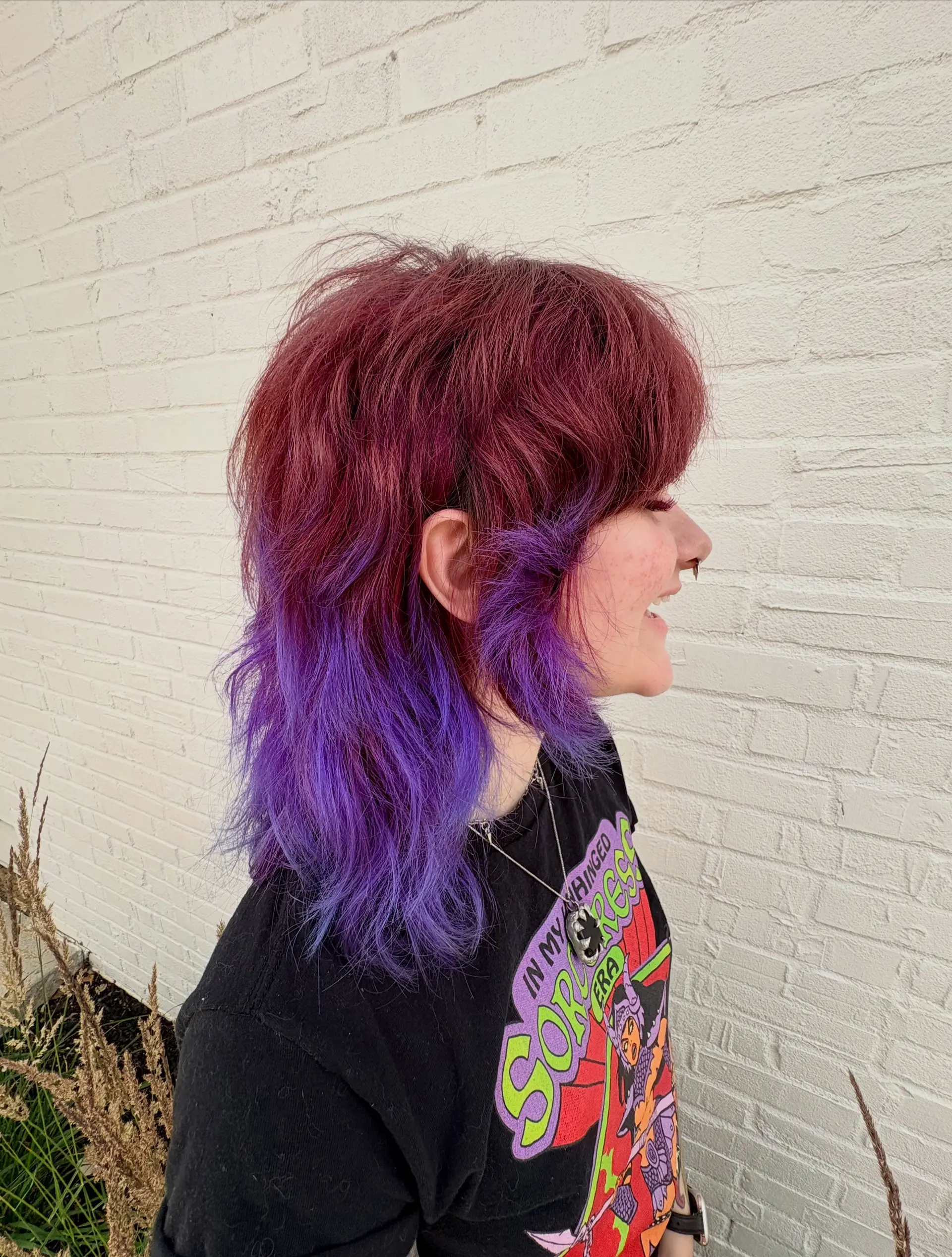 A heavily textured shag mullet featuring full fringe, choppy layers, and a vivid two-tone color transition from deep magenta to bright violet purple. 1