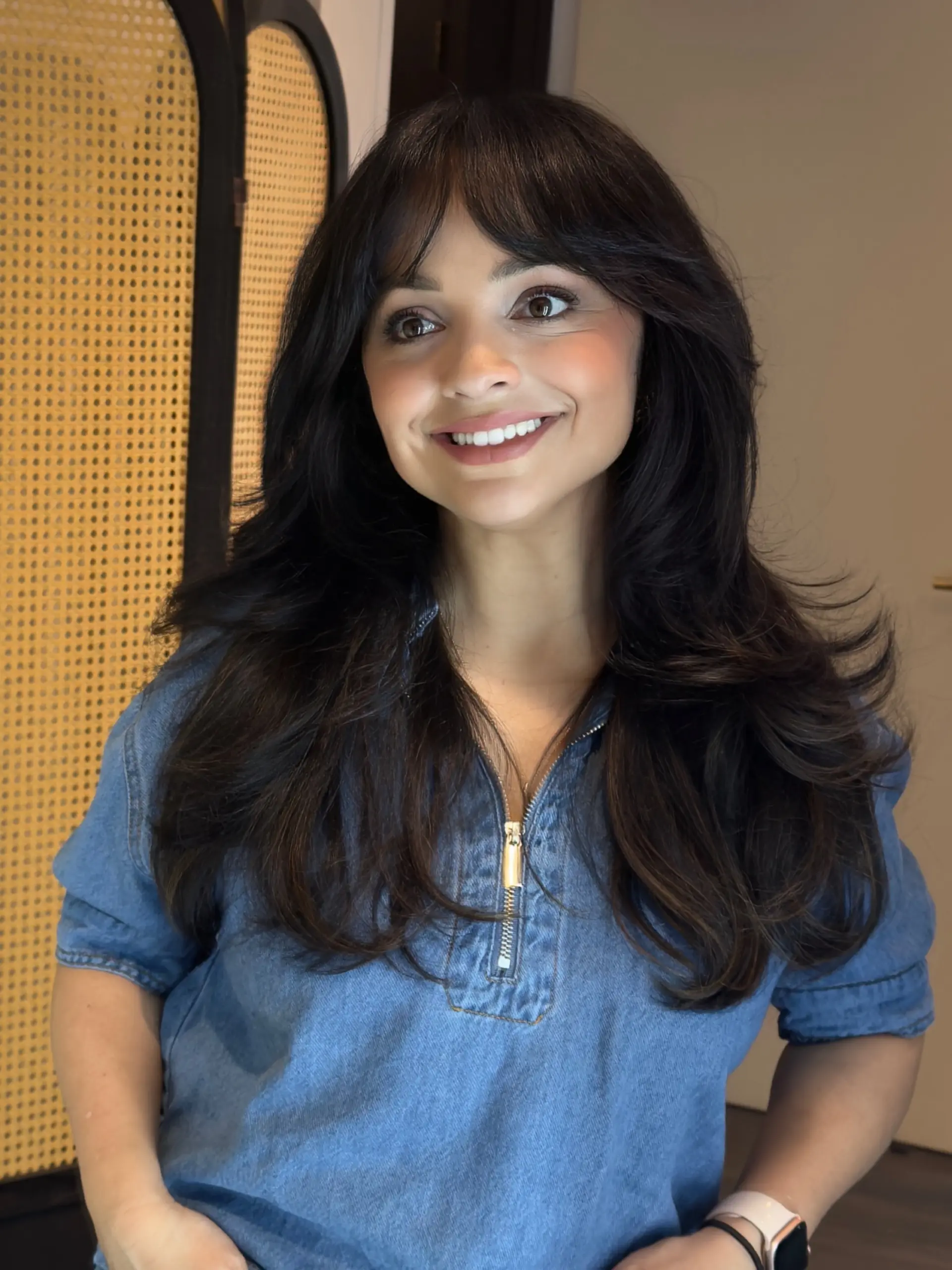 A voluminous butterfly haircut with feathered, cascading layers and soft curtain bangs. 1