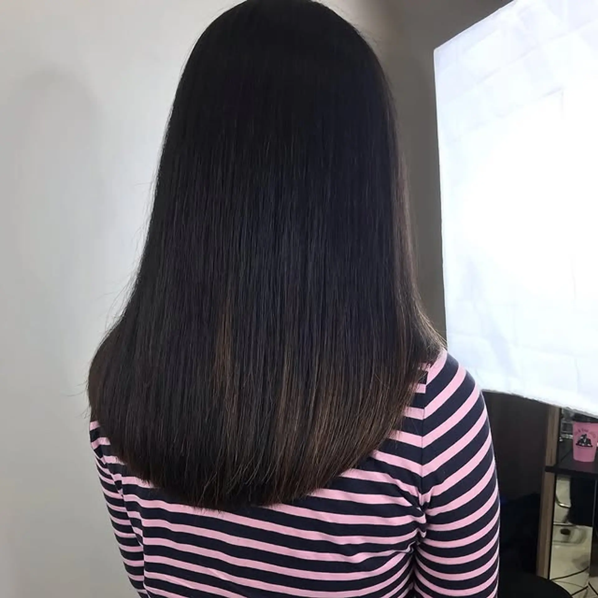 A sleek, layered long hairstyle with a subtle chocolate balayage. 1