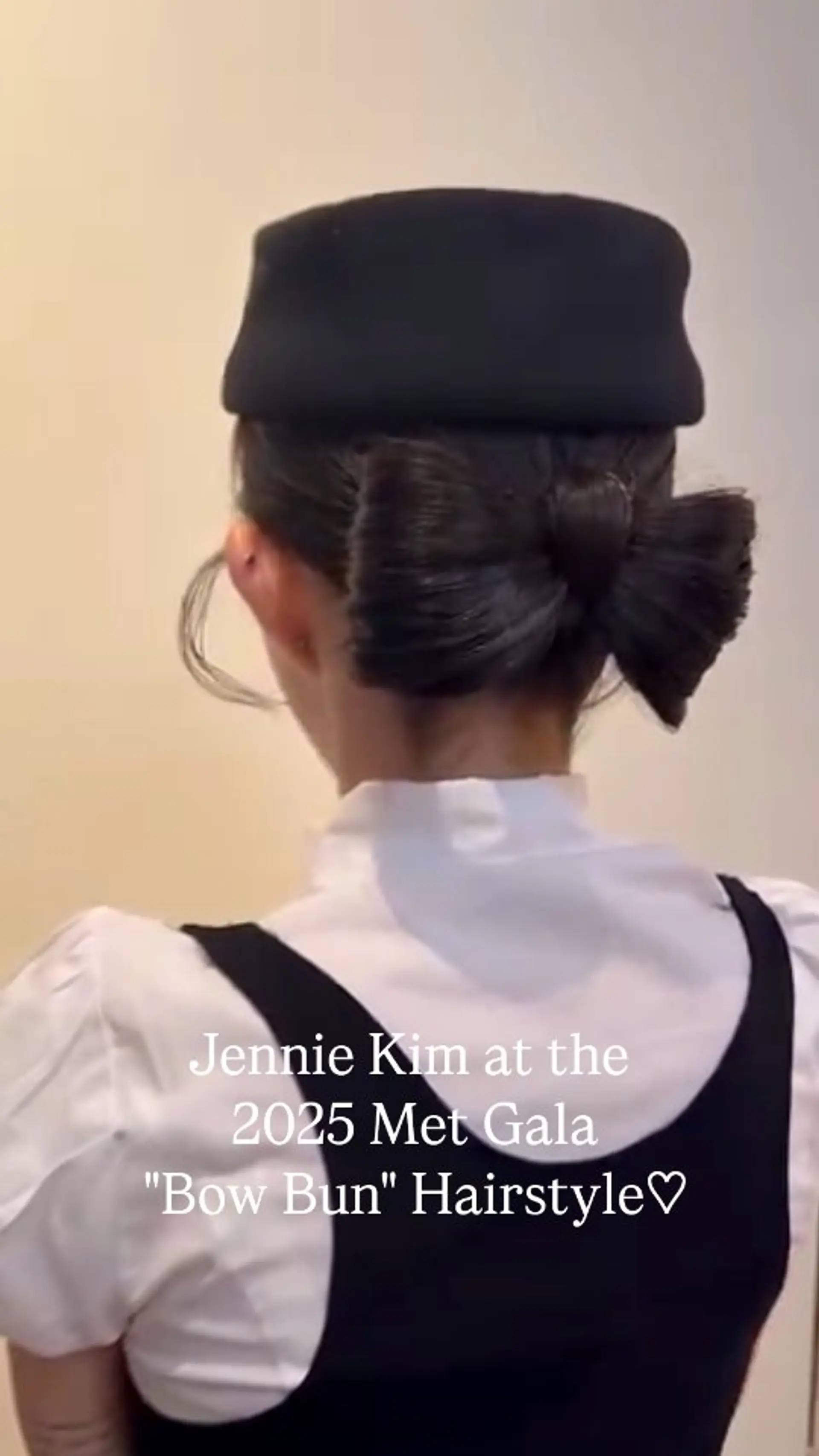 A sleek, sculpted hair bow bun up-do gathered smoothly at the nape of the neck. 1