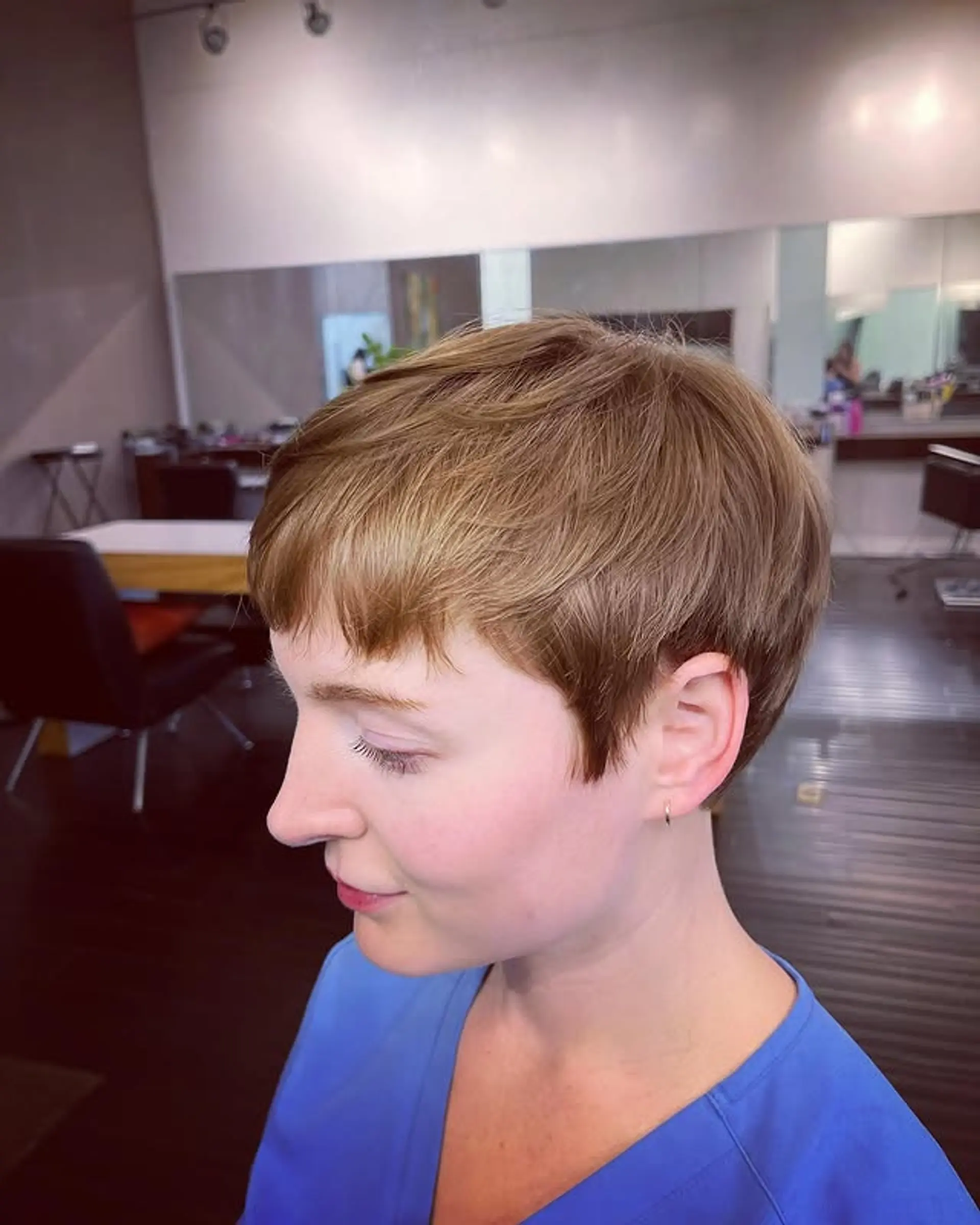 A short, textured pixie cut with bangs. 1