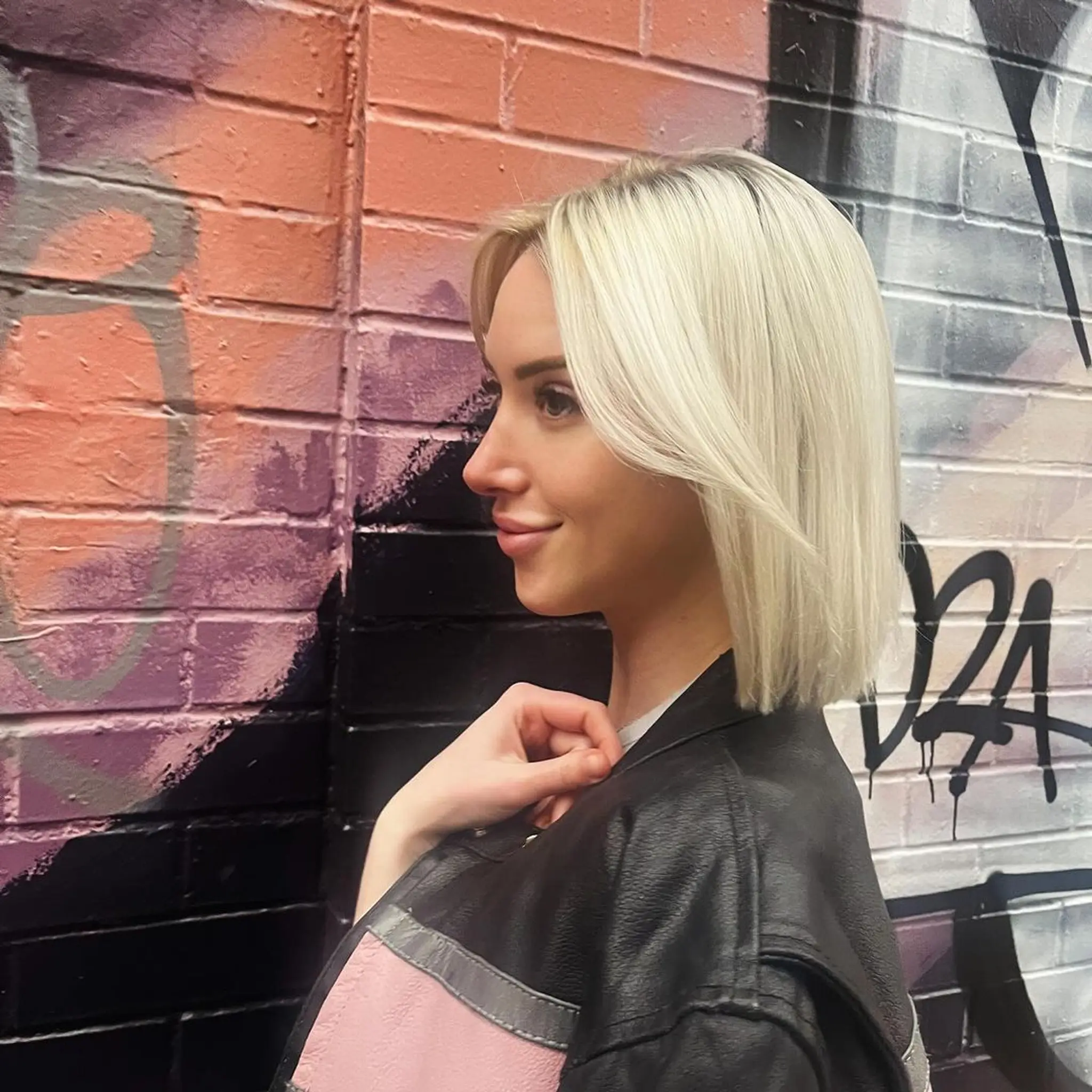 Chic platinum bob with a side part, sleek and straight texture, blunt ends, and shoulder-length cut. 1